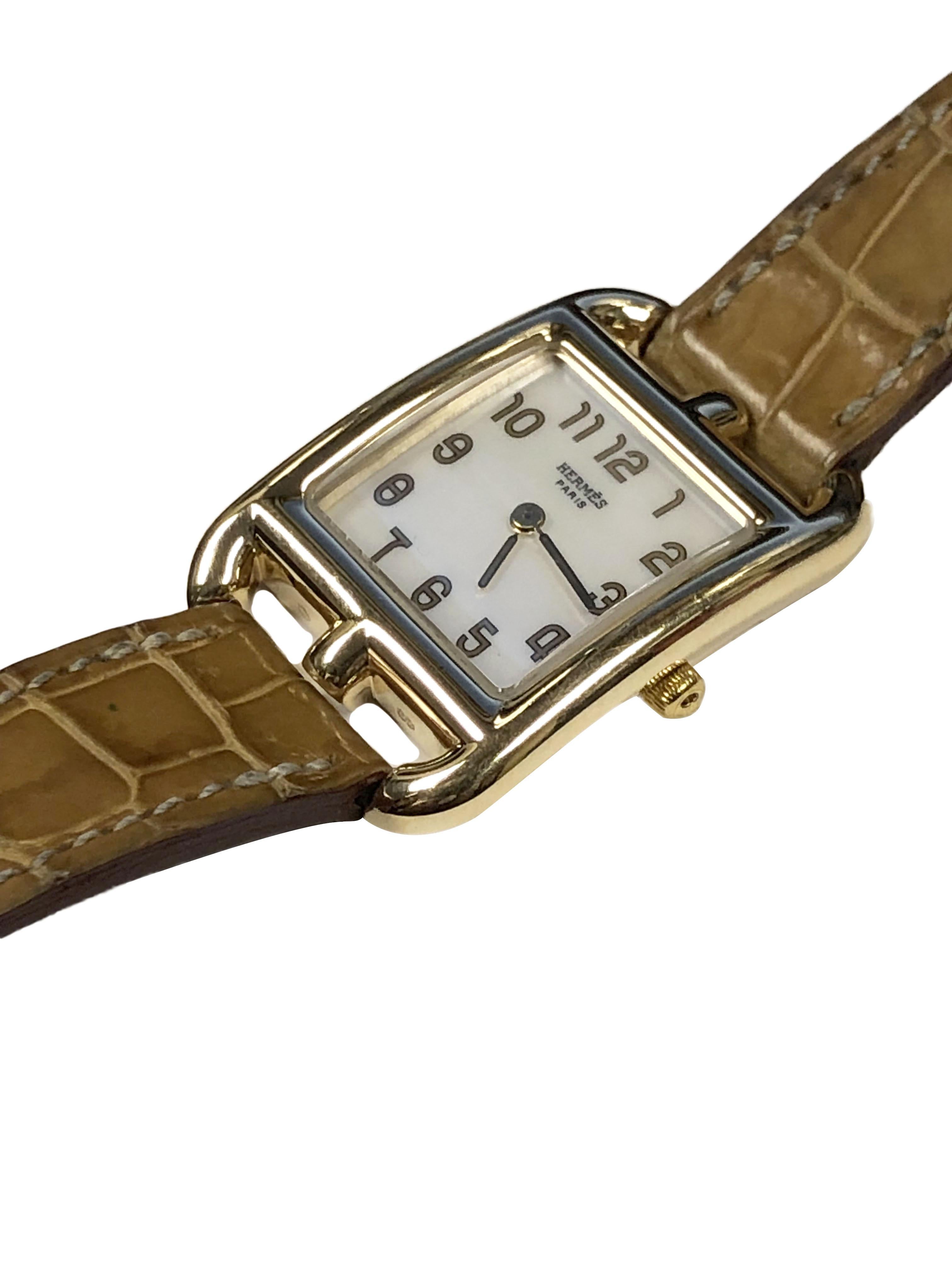 Circa 2010 Hermes Ref: CC1.285 Cape Cod collection Ladies Wrist Watch, 33 x 23 M.M. 18k Yellow Gold 2 piece water resistant case. Quartz movement, White Mother of Pearl Dial with Gold numerals. original Hermes Tan Croco strap with 18k Gold buckle.