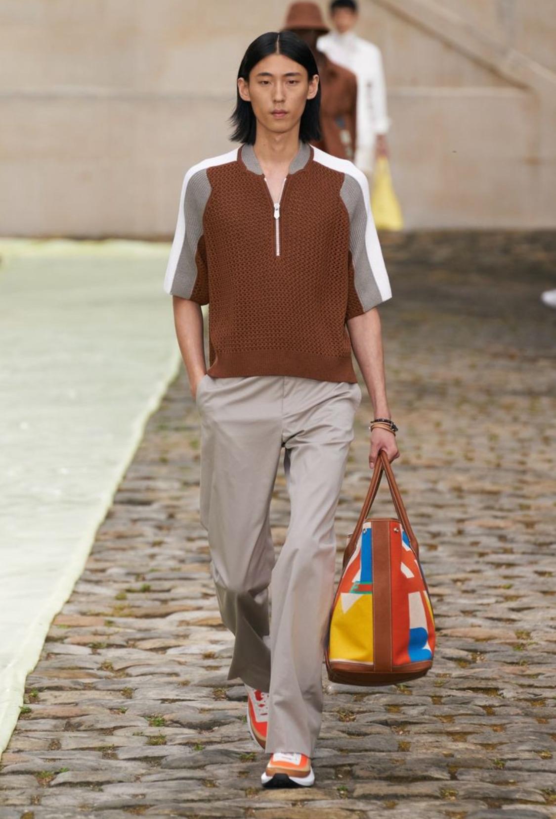 The Hermes Capucine Garden Party 49 Voyage Tote Bag is a stunning embodiment of vibrant sophistication, perfect for those who appreciate both style and functionality. This spacious tote, crafted in durable canvas, features delightful hues of orange,