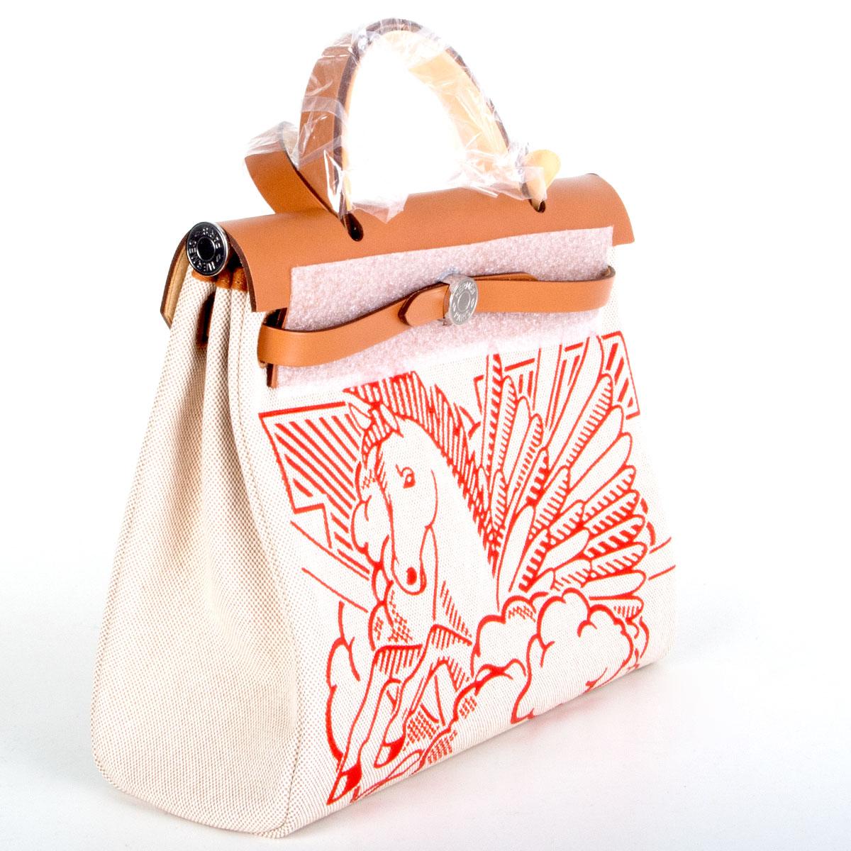 authentic Hermès 'Pegase Pop Herbag Zip 31 Retourne' shoulder bag in Ecru-Beige (oatmeal) Toile H canvas with Capucine red print and details in Nature (tan) Vache Hunter leather. Exterior zip pocket on the back. Closes with two straps on the front.