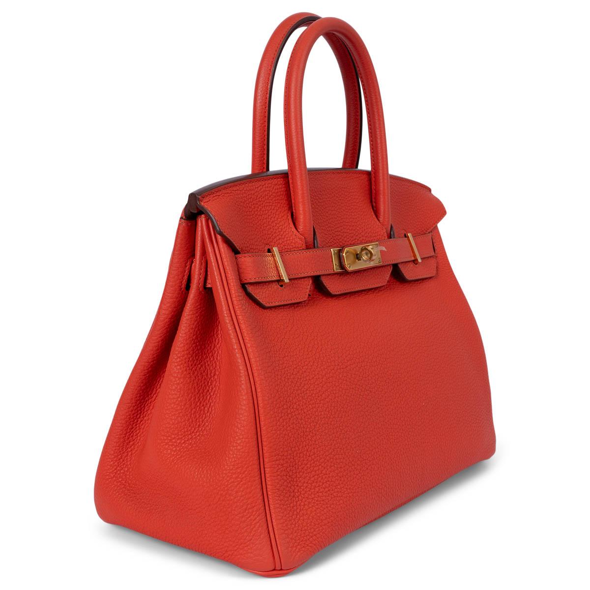 100% authentic Hermès Birkin 30 bag in Capucine orange Togo leather with gold-plated hardware. Lined in Chevre (goat skin) with an open pocket against the front and a zipper pocket against the back. Has been carried once or twice and is in virtually
