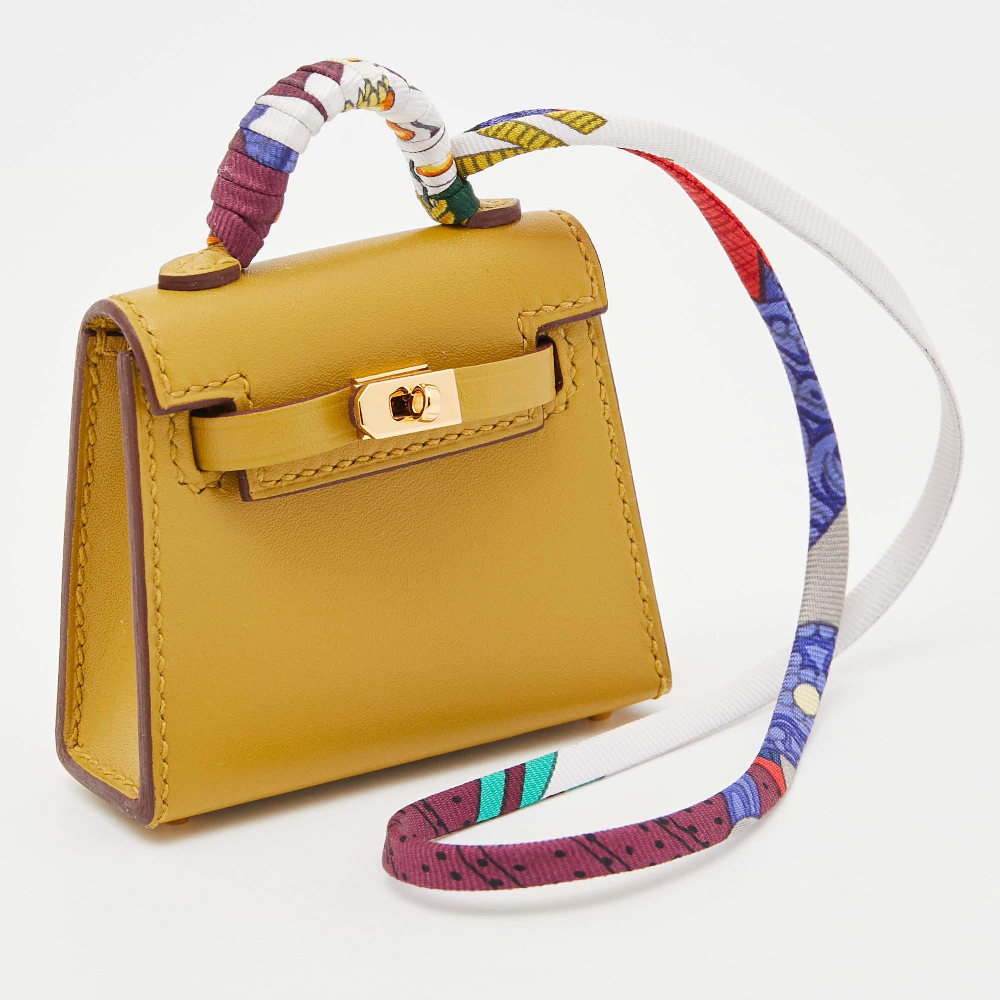 Wondering how to decorate your Kelly bag? Use this mini Kelly twilly bag charm! It is crafted using leather into the structure we love so much. It has the signature handles, and the front lock can be unclasped too.

Includes
Original Dustbag,