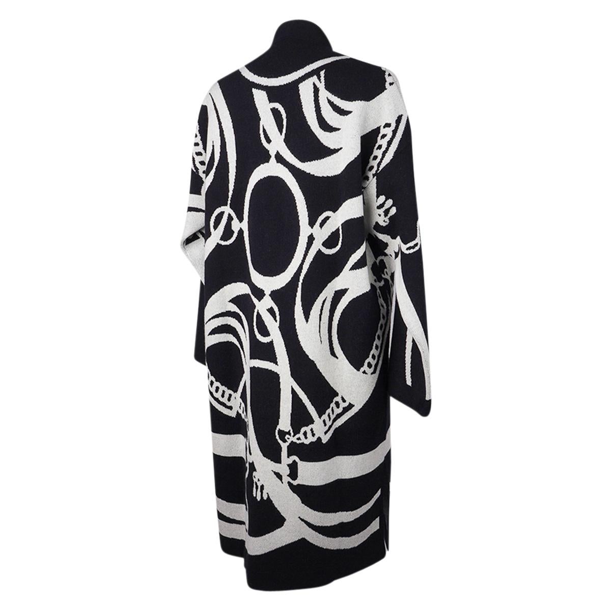 Mightychic offers an Hermes Promenade du Matin over sized long cardigan coat featured in Black and White.
Drop shoulder long cardigan coat has a jacquard knit with Promenade du Matin intarsia motif.
V-neck with one tone on tone corozo button midway