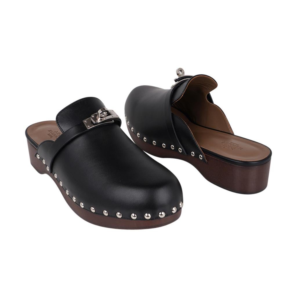 Hermès - Mules Carlotta en cuir de veau noir avec boucle Kelly en palladium, 39 / 9, neuves dans leur boîte Pour femmes en vente