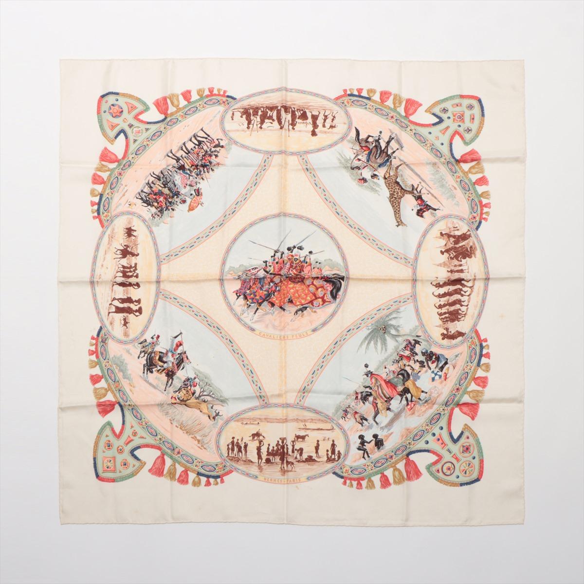 The Hermès Carré 90 Cavaliers Peuls Pool Jockey Scarf in ivory is a beautiful silk accessory that showcases the brand's exquisite craftsmanship and artistic heritage. The scarf features a detailed illustration inspired by the Peul people, known for