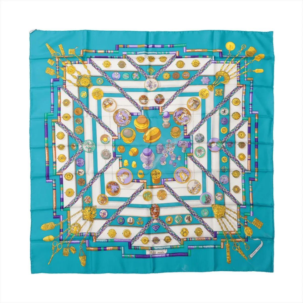 The Hermès Carré 90 Petite Main Silk Scarf in Blue is a vibrant and elegant accessory that showcases the brand’s artistry and craftsmanship. Crafted from luxurious silk, it features the intricate “Petite Main” design, celebrating the skilled hands