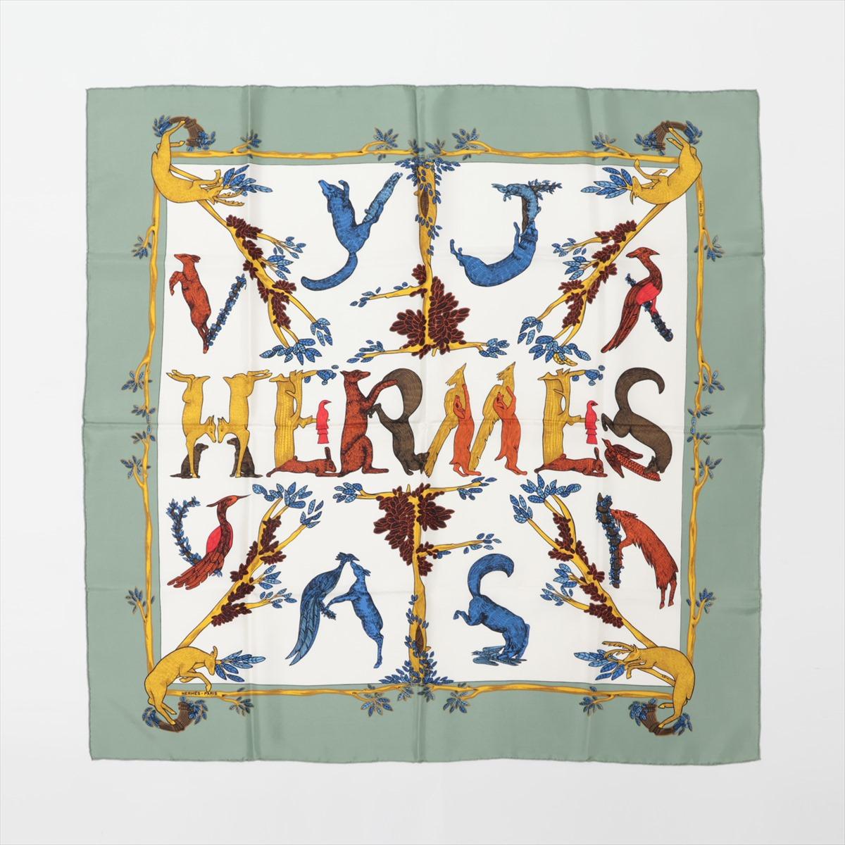 The Hermès Carré Animal Alphabets Scarf in White and Green is a stunning accessory that seamlessly combines luxury and whimsy. Crafted from luxurious silk, the scarf features a playful print showcasing a menagerie of animals arranged in an alphabet