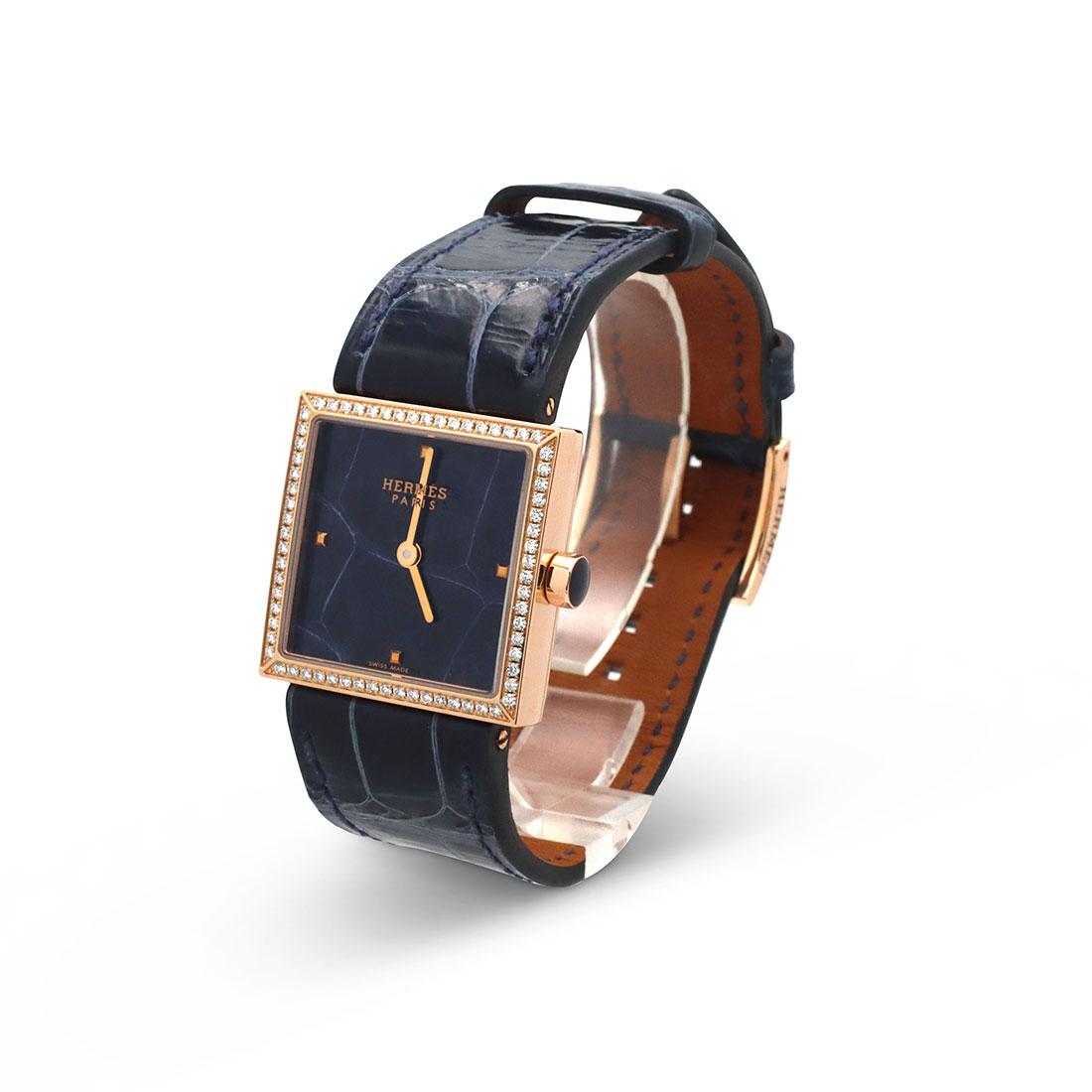 Authentic Hermès 'Carré Cuir' ladies watch crafted in 18 karat rose gold.  The square case measures 24mm x 24mm and the bezel is set with round brilliant cut diamonds.  The unique dial mirrors the blue alligator skin strap.  Swiss quartz movement. 