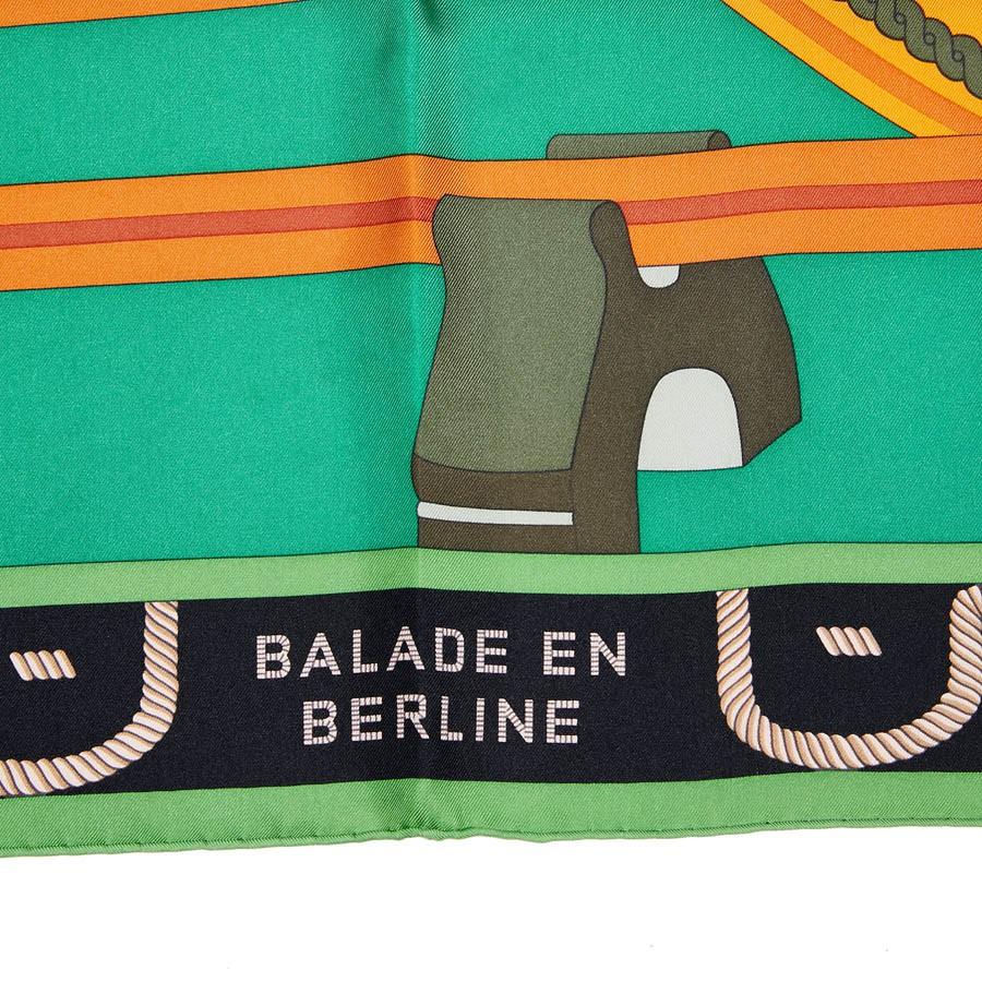 Never worn, with the box, this scarf is made of Silk, 100%, as written on the composition label. Designed by Wlodek Kaminski it shows a coach designed with green and orange. Made in France. 
Dimensions : 90 x 90 cm.