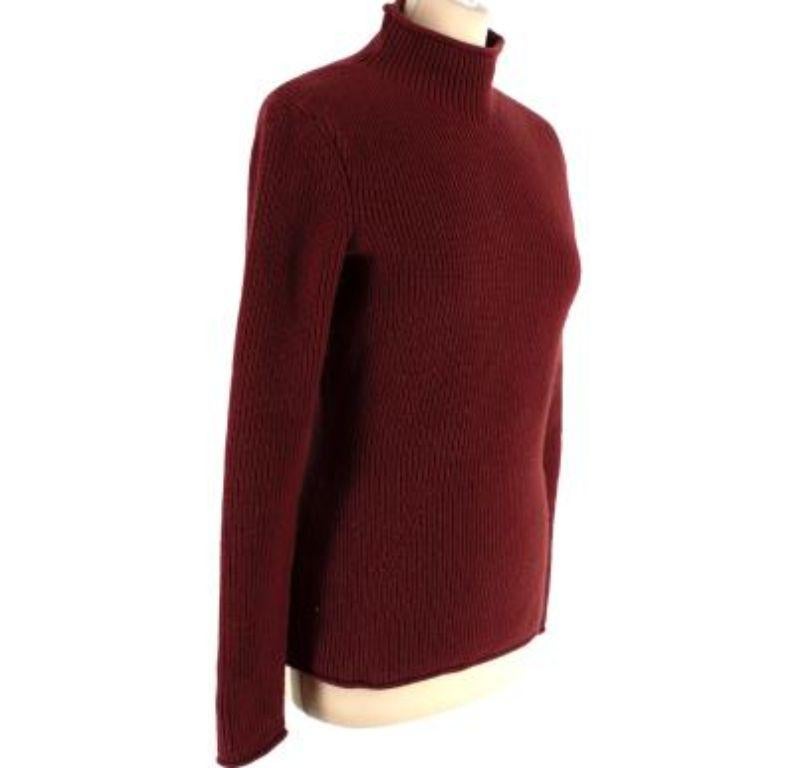 Hermes Cashmere Maroon Sweater

- Soft knitted cashmere maroon Hermes sweater with small silver-coloured metal hardware features
- Knitted wave-like pattern down front body
- Mid-rise turtle neckline

Materials:
100% Cashmere

Made in