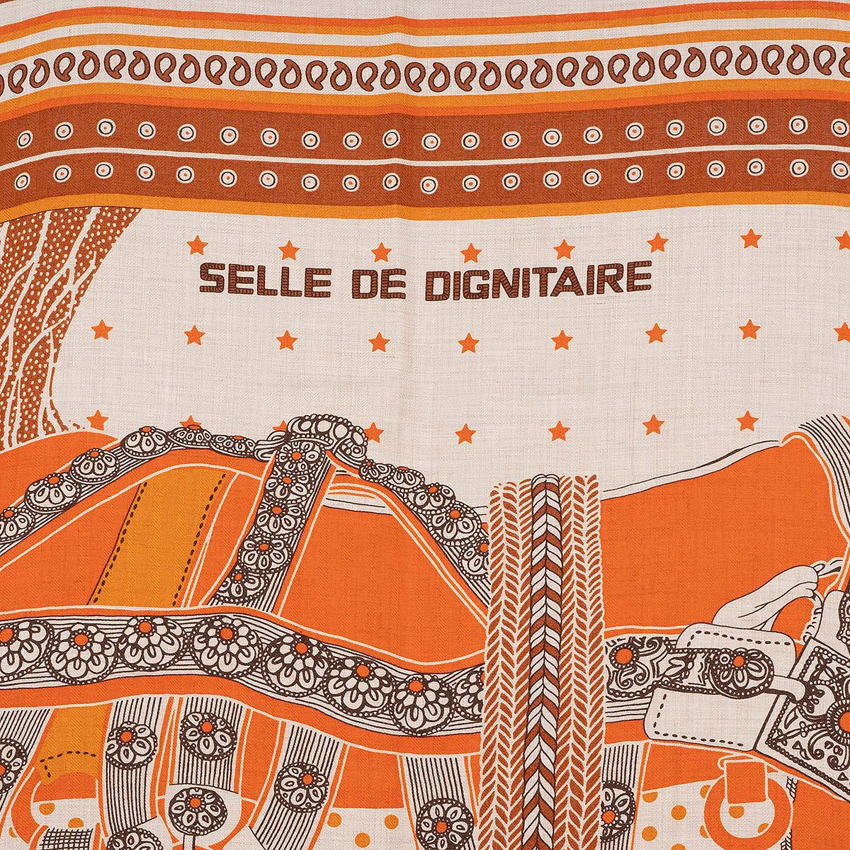 100% authentic Hermès 'Selle de Dignitaire 140' shawl in orange cashmere (70%) and silk (30%) with background in natural and details in brown, chestnut and grey.Has been worn once and is in virtually new condition. 

Measurements
Width	140cm