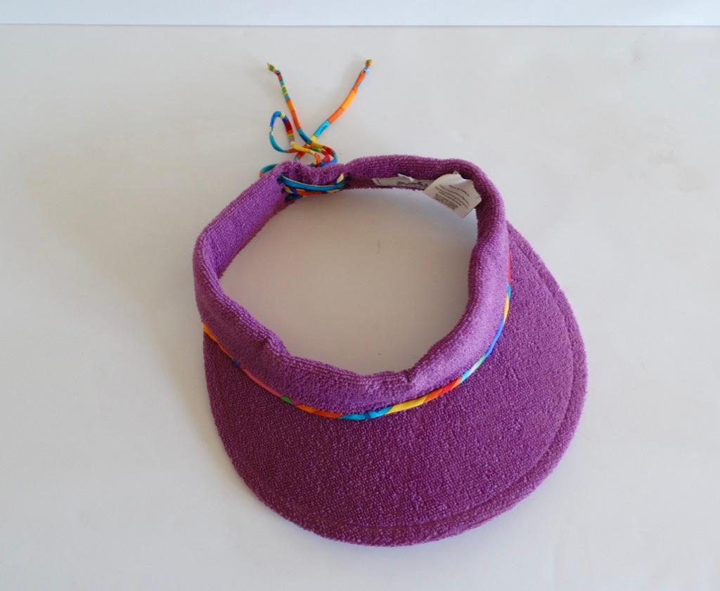 Stay chic while keeping those sun rays off your face with our lovely Hermès Paris Terry cloth sun visor. From their Casquette Oasis collection, this visor is a meduse purple with a silk twisted multi color lace up back detail. Sz 57 Head