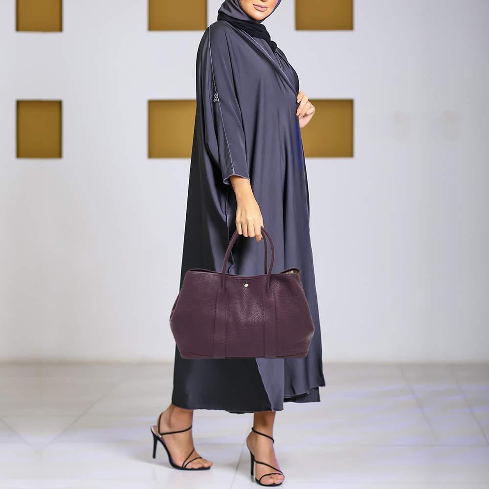 You'll love swinging this exquisite Garden Party 36 from Hermes. This beauty has been meticulously crafted from Cassis Negonda leather, with two top handles on top for easy styling. Its lined interior is perfectly sized to carry your essentials,