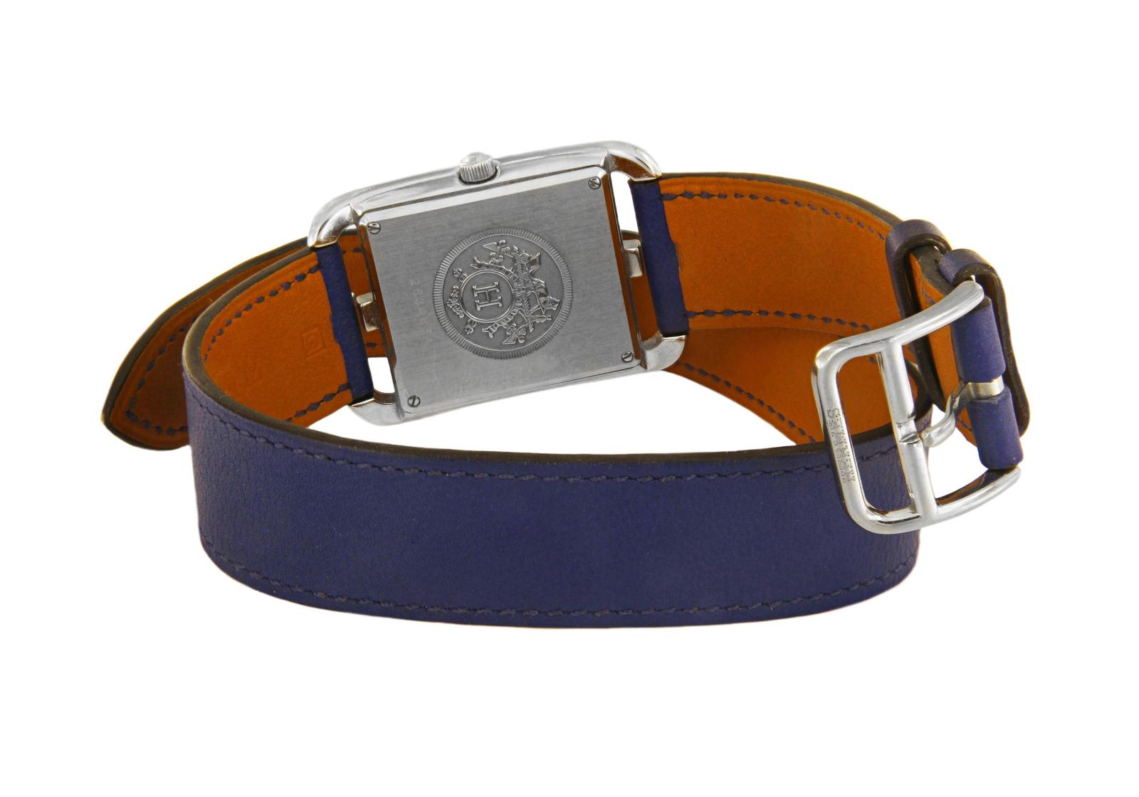 HERMES CASSIS SWIFT LEATHER AND STAINLESS STEEL CAPE COD PM DOUBLE TOUR WATCH CC

-Mint condition
-Case size: 29x40mm
-Movement: Quartz
-Stainless steel case
-Arabic numerals
-Date indicator
-Blue leather strap
-Closure: Double wrap around with