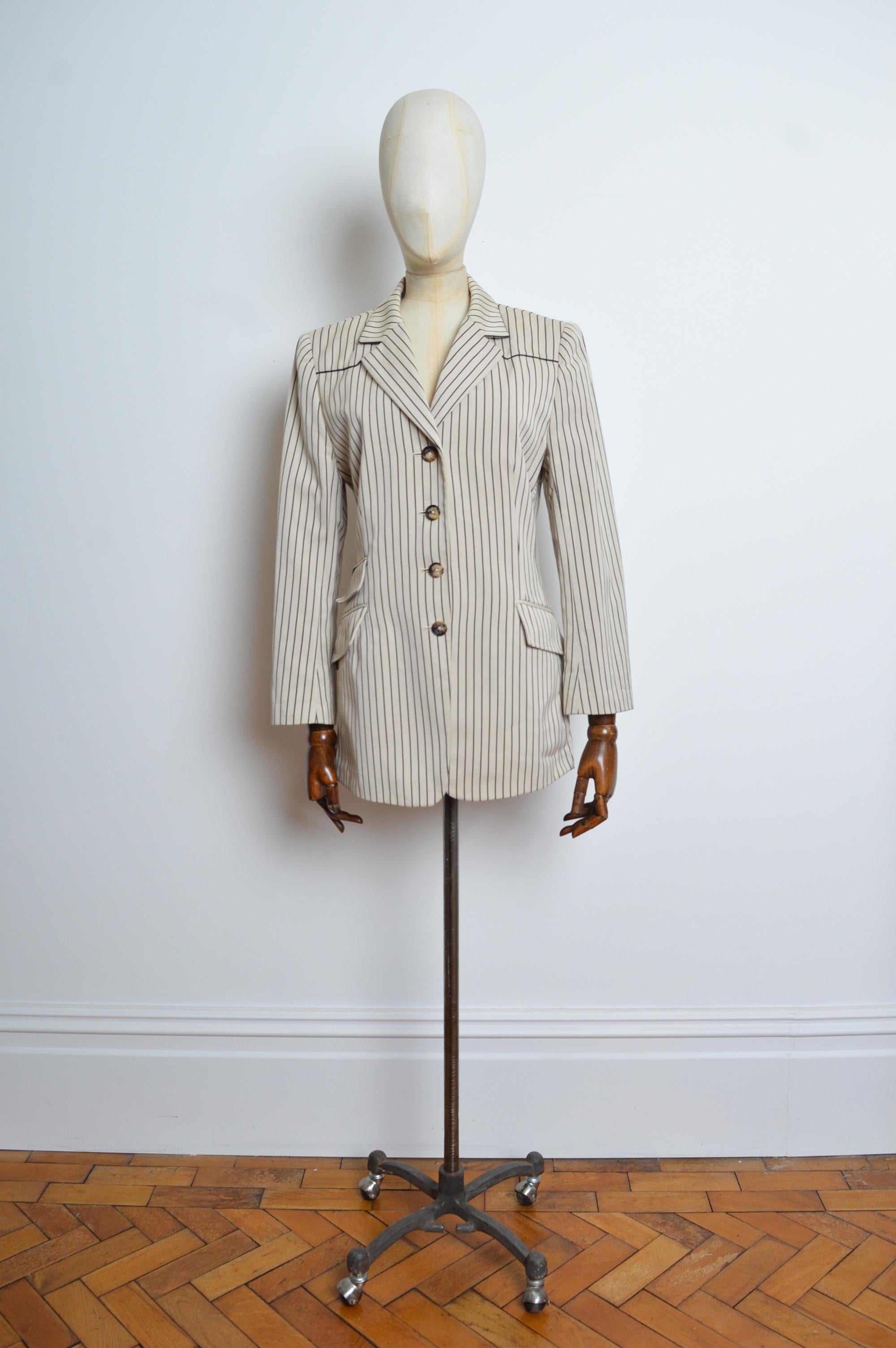 A Preppy, Chic Vintage Hermés Ticking striped Blazer in Ivory with fine black lines, which offer a trompe l'oeil slimming effect on the silhouette.
MADE IN FRANCE. 
Recommended Size ; UK 10
Pit to Pit; 20”
Pit to Cuff; 16”
Nape to Hem; 33”
Features;