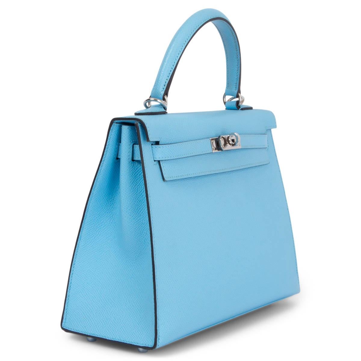 100% authentic Hermès Kelly 25 Sellier bag in Celeste (light blue) Veau Epsom leather with palladium-plated hardware. Lined in Chevre (goat skin) with an open pocket against the front and a zipper pocket against the back. Has been carried with some