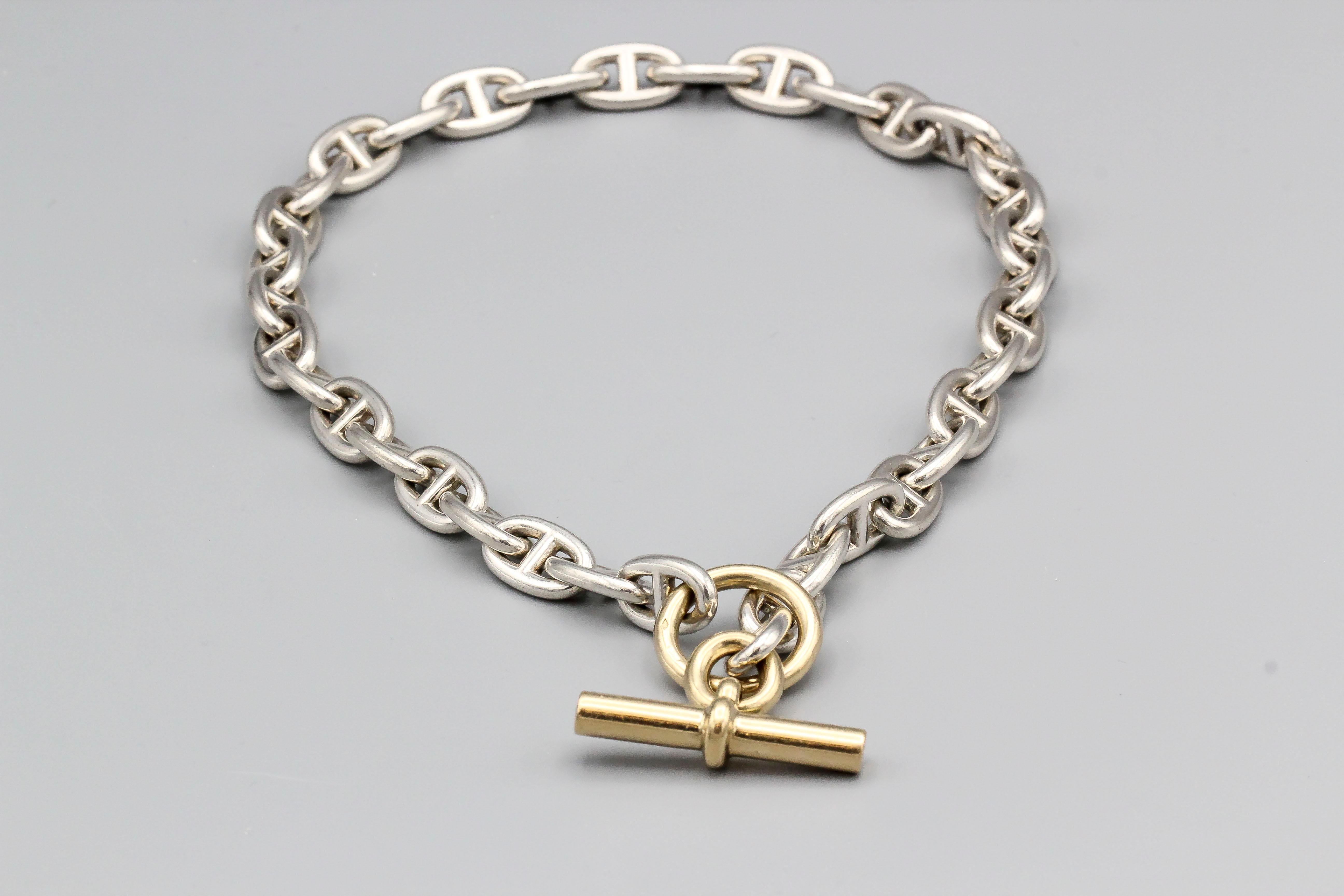 Stylish 18K gold and sterling silver toggle link necklace , from the Chaine D'Ancre collection by Hermes.  It is the large size and features an 18k gold toggle with sterling silver links.

Hallmarks: Hermes, French 18k gold assay mark, maker's mark.