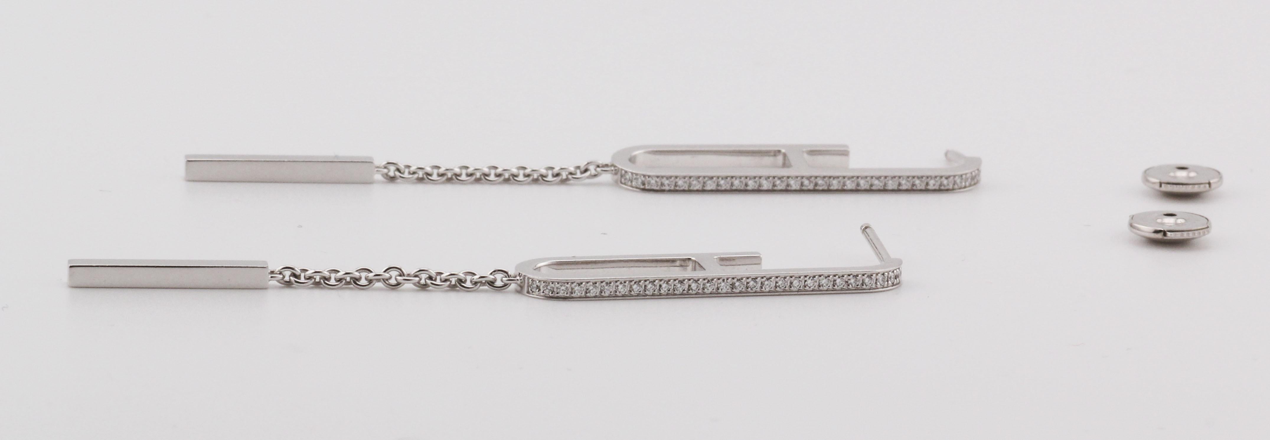 The Hermès Diamond 18K White Gold Dangling Earrings are a stunning expression of luxury and elegance, perfectly encapsulating the brand's renowned craftsmanship and sophisticated design ethos. These exquisite earrings are crafted from the finest 18K