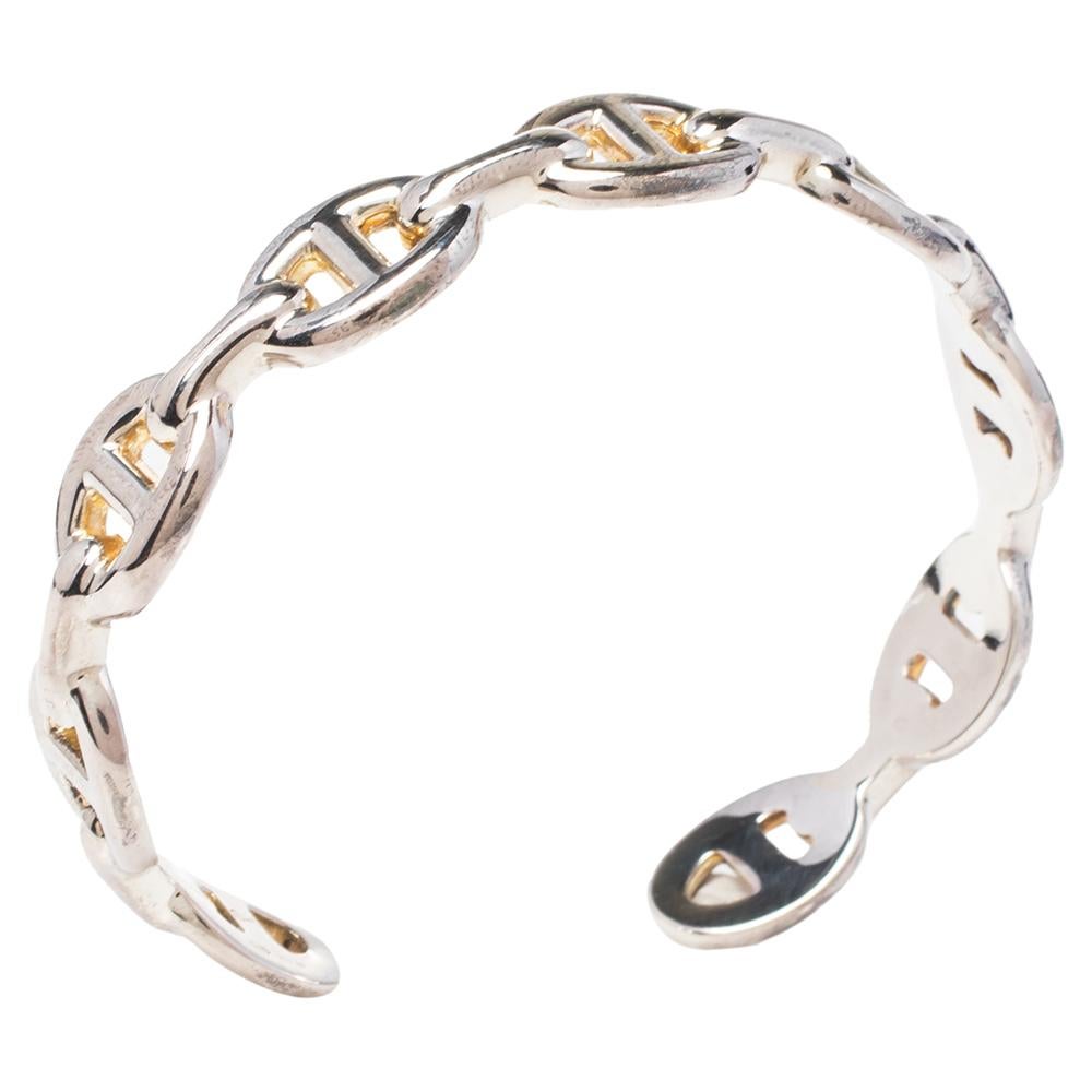 This elegant design of the Chaine d'Ancre Enchainee bracelet is inspired by the ship anchor chain and has a refined look that will go with any dress or look. This creation features an open-cuff silhouette with multiple links attached together. It is
