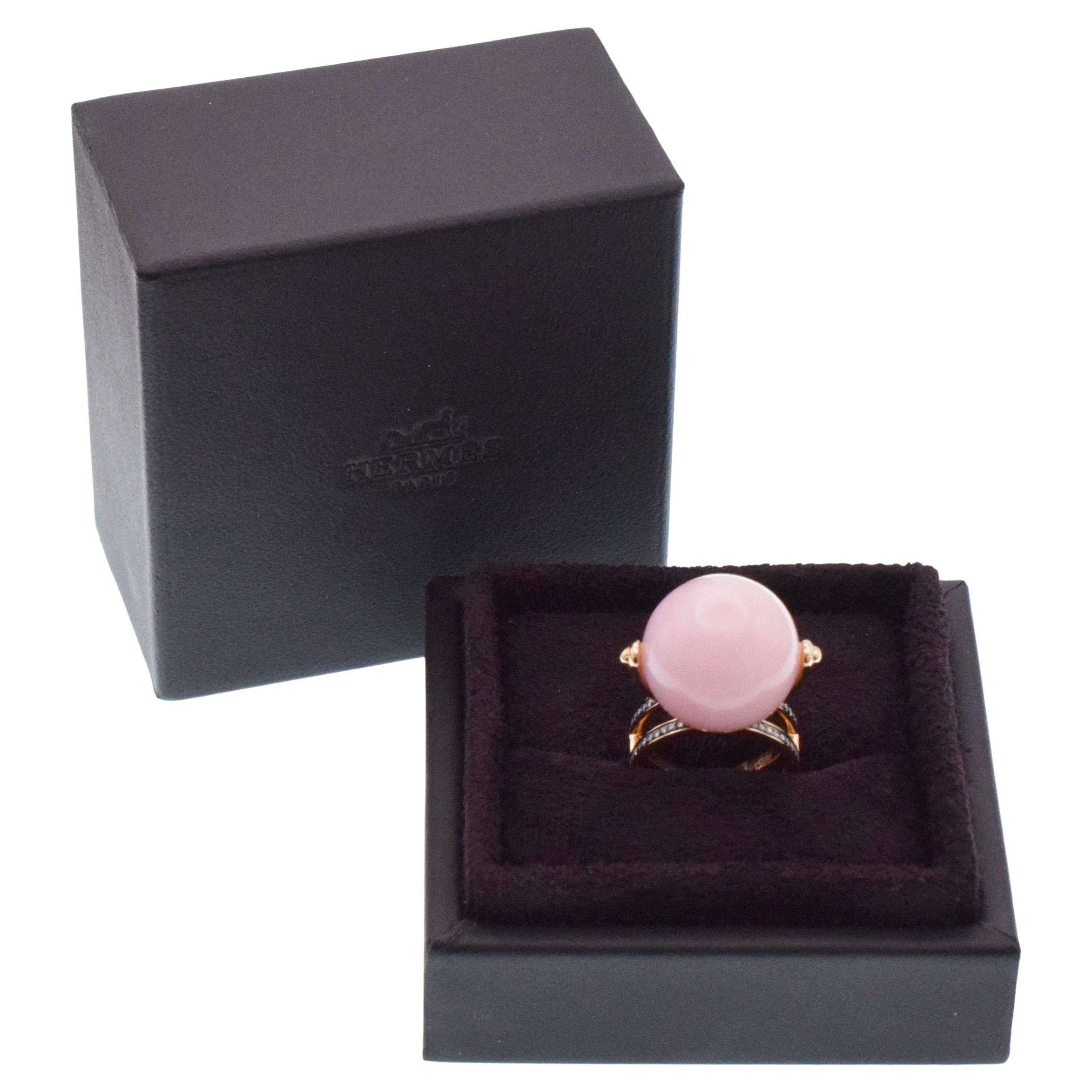Hermes Chandra pink opal ball and diamond ring in 18k rose gold. The center features 18mm pink opal bead, mounted on Chaine d’Ancre diamond pave set band. Encrusted with 108 round brilliant cut diamonds with total weight of approximately 0.55ct,