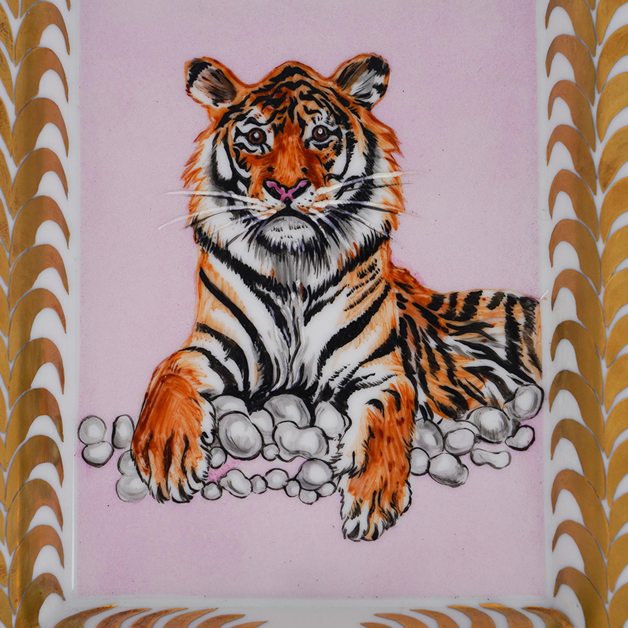 Mightychic offers an Hermes Tigre Royal featured in Gold (Or) and Rose ashtray.
Hand-painted Limoges Porcelain.
This magnificent regal tiger is a collectors treasure.
A decorative ashtray or tray piece perfect for any room.
Protected by velvet