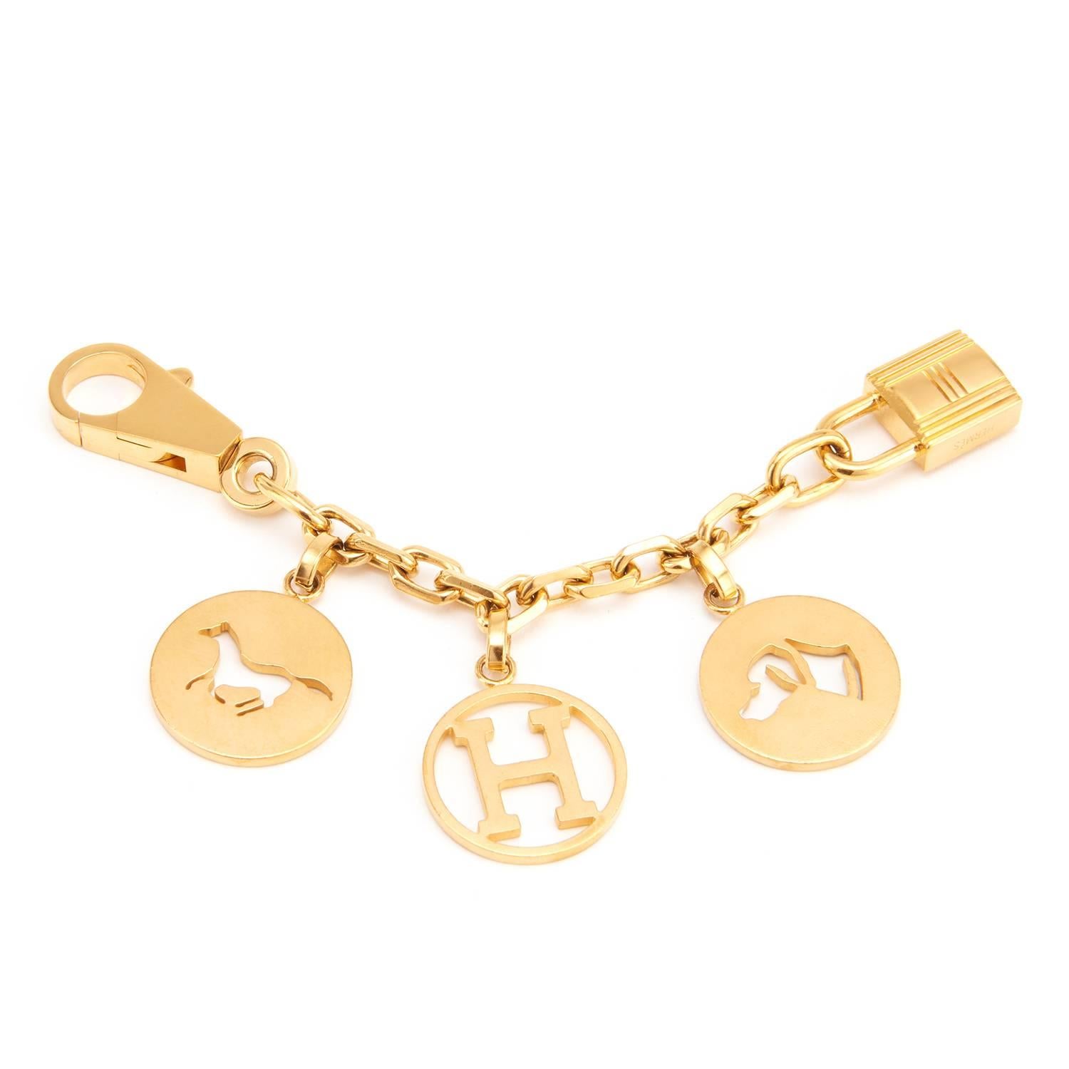 Hermes Breloque Charm Gold GHW Bag Charm for Birkin or Kelly  
Extremely rare item.
A most adorable Hermes bag charm in desirable GOLD for your Birkin or Kelly. 
Featuring the iconic horse, dog, and H charms on a chain, the Breloque Charm is one of