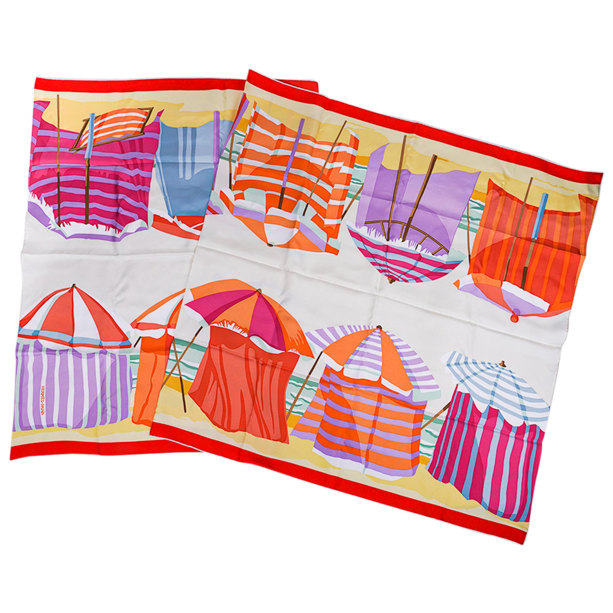 Mightychic offers an Hermes Charmes des Plages Normandes Rectangle silk rectangular scarf.
Featured in Nacre and Grenadine colorway.
Depicts the colorful beach tents on the beautiful beaches of Normandy, i.e. Deauville and Trouville.
This beautiful