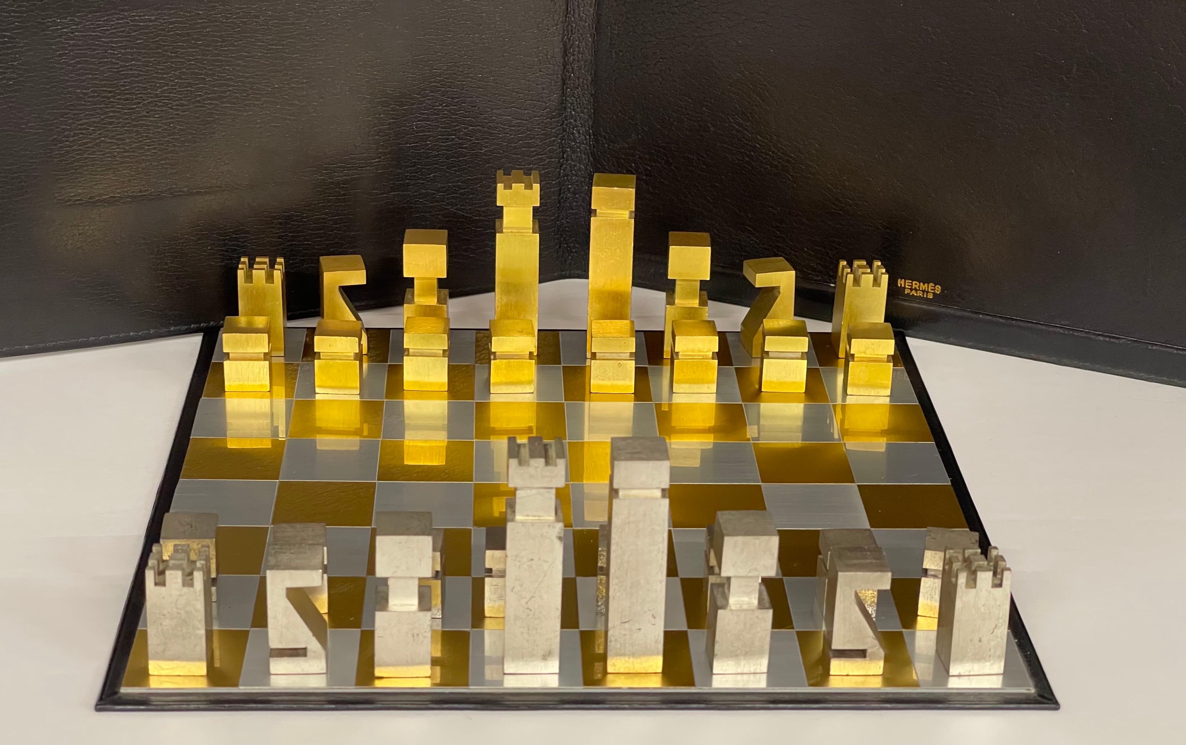 A beautiful and elegant chess set designed by Rena Dumas for Hermes circa 1985. Come with a leather folder. Pieces are made of steel and brass. The King is 2 1/2 inches tall and the pawns are 7/8 inch tall. There is some tarnish to the pieces and