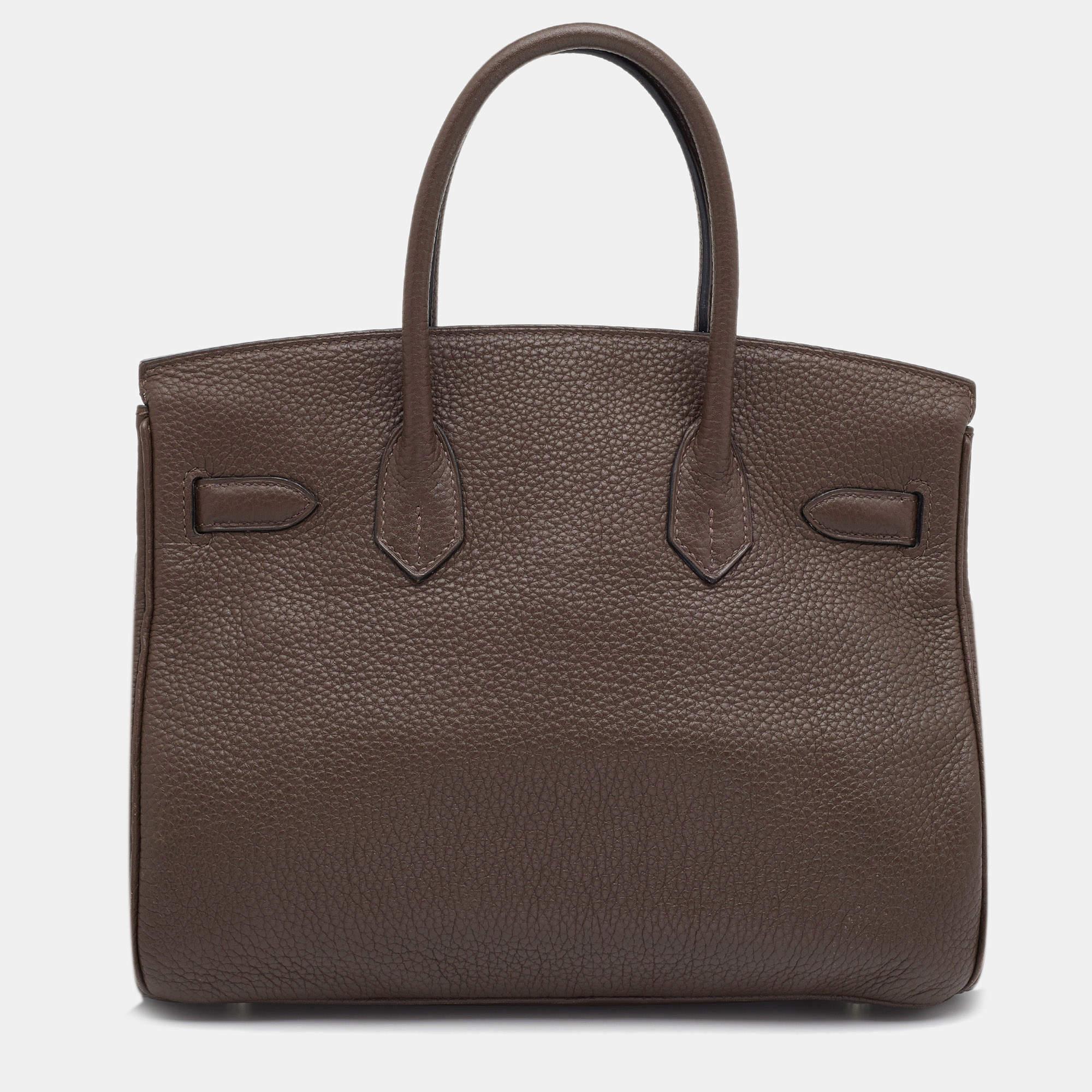 If you've wished to own an authentic Birkin, there is no better time to buy this coveted work of art than now. Here, we have this Chocolat Taurillon Clemence Birkin 30 just for you. Crafted in France from leather, the bag features dual top handles.