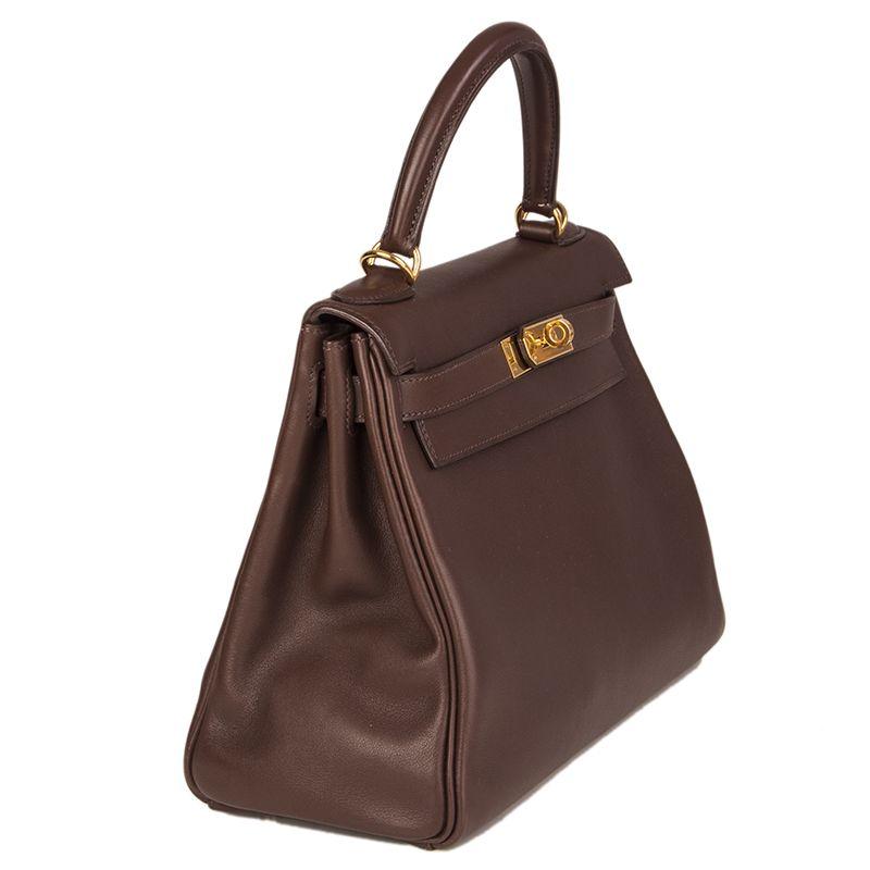 Hermes 'Kelly II 28 Retourner' bag in Chocolate brown Veau Swift leather with gold hardware. The interior is lined in Chevre (goat skin) with a divided open pocket against the front and a zipper pocket against the back. Has been carried and is in