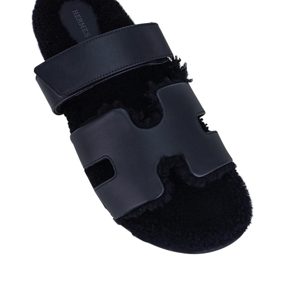 Mightychic offers a pair of limited edition Hermes Men's Black Chypre calfskin and Veau Indios Woolskin sandals.
The iconic H cutout over the top of the foot in calfskin  with black shearling insole and H embossed rubber sole.
Timeless.
Strap across