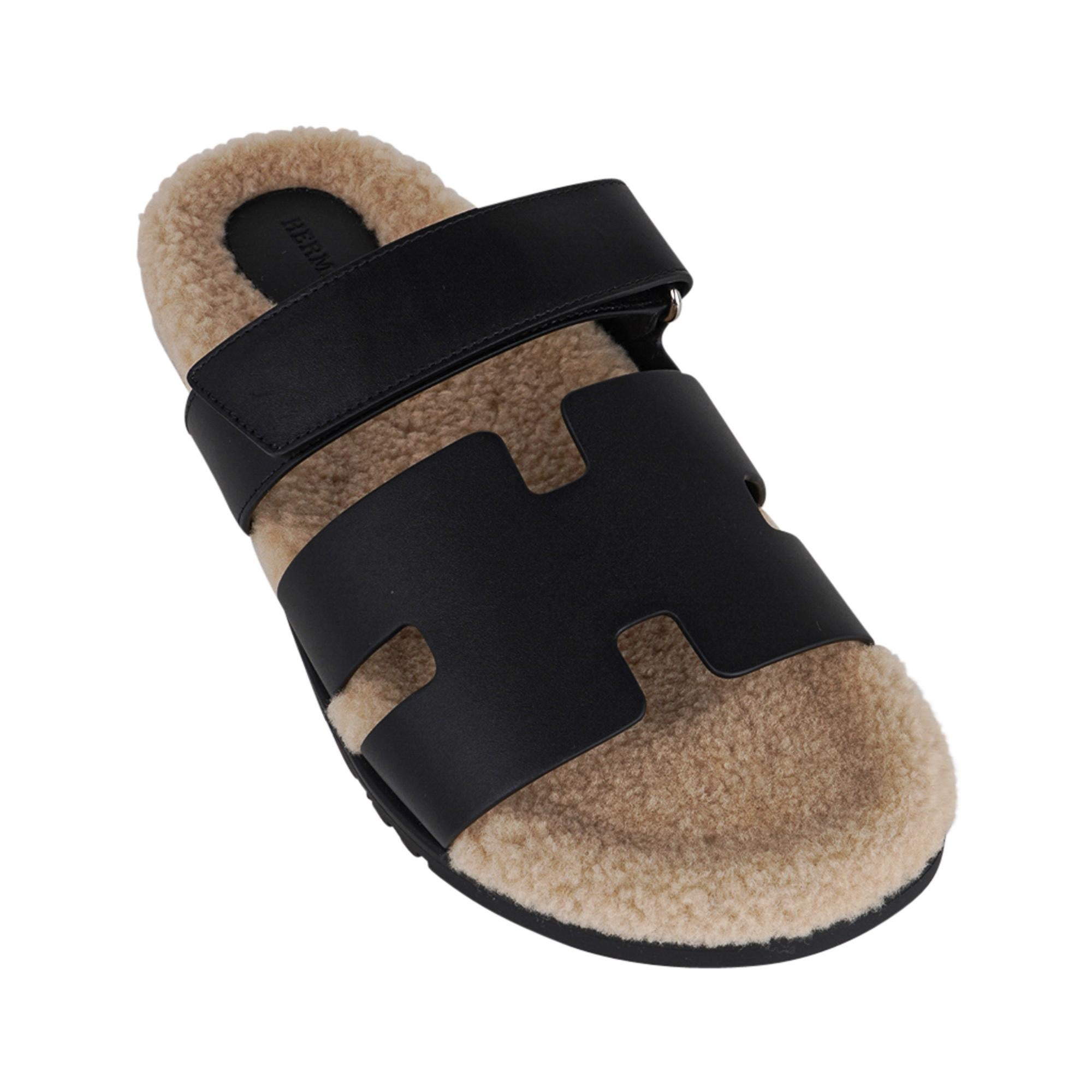 Mightychic offers an Hermes Men's Black Chypre Veau Indios Woolskin sandal.
The iconic H cutout over the top of the foot in Calfskin with ecru woolskin insole and H embossed rubber sole.
Strap across foot is adjustable with velcro closure.
Comes