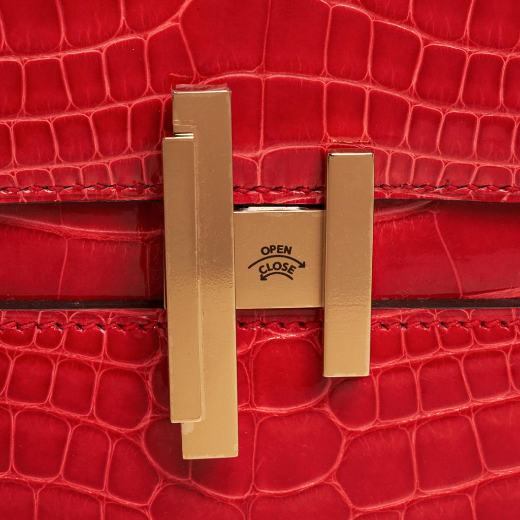 Guaranteed authentic Hermes Cinhetic bag featured in Rouge de Coeur.
Alligator and permabrass hardware.
Fresh new shape with architectural H that turn easily to open. 
Top handle and beautifully designed chain link shoulder strap.
Signature stamp