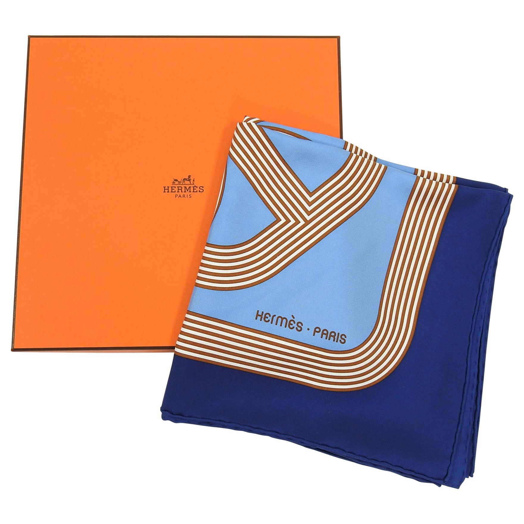 Hermes Circuit 24 Faubourg Silk Twill 90cm Scarf in Box.  Graphic Hermes interlocking Chaine d’ancre horse bit design in navy, light blue, brown, and white.  Excellent pre-owned condition.  Includes box, retail tag. 100% silk twill.