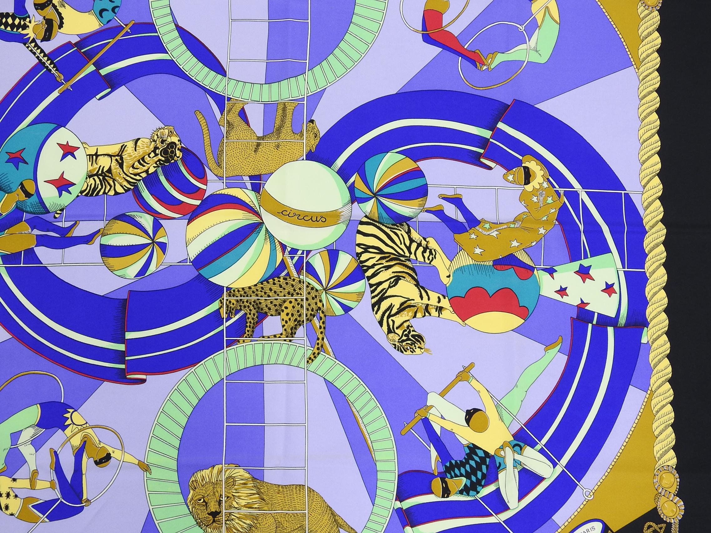 Hermes Circus Black and Purple 90cm Silk Scarf.  Design features acrobat and jungle cat circus scenes in black, purple, yellow, gold, and blue colors. Excellent pre-owned condition.  
