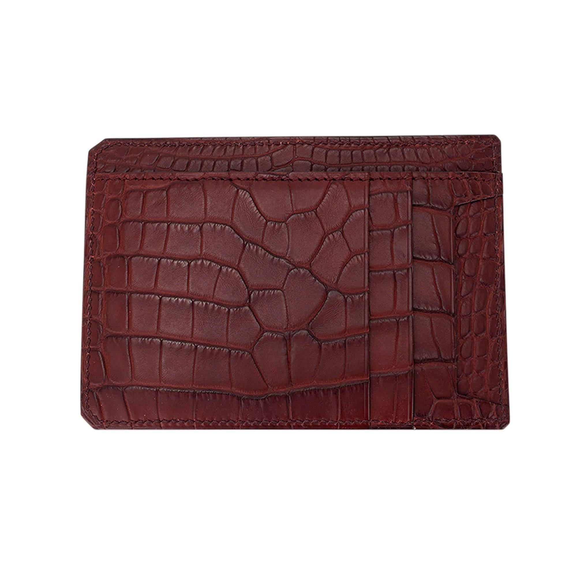 Mightychic offers an Hermes City 8CC Card Holder featured in classic and iconic Rouge H matte alligator.
As part of the City line of cardholders, it is compact and lightweight.
There are 8 elongated slots for business and or credit cards. Minimalist