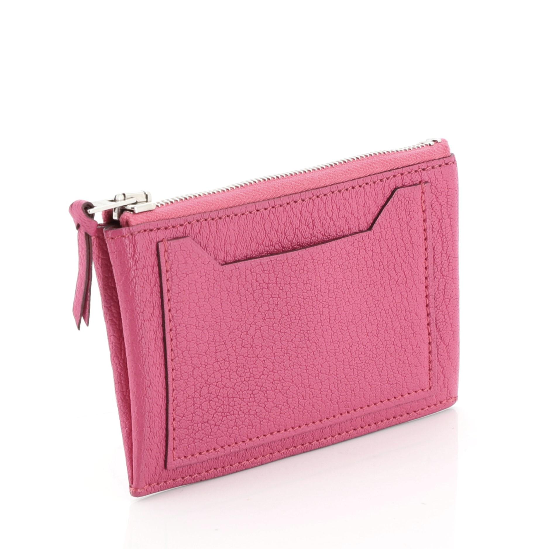 This Hermes Clarisse Zip Pouch Chevre Mysore PM, crafted from pink leather, features an exterior slip pocket and palladium hardware. Its zip closure opens to a pink leather interior. 

Estimated Retail Price: $525
Condition: Excellent. Minor wear on