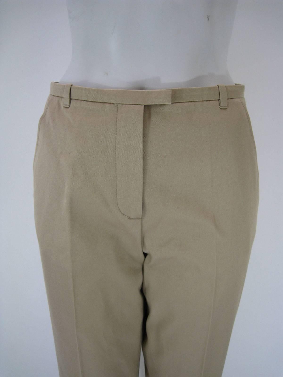 Classic Hermes khaki slacks.

Light tan color.

Straight legged.

Flat front.

Front zipper, button and hook closure.

Side pockets and one back pocket.

Belt hoops.

Tagged size 38.

Made in Italy.

This item is in good pre-owned condition. No rips