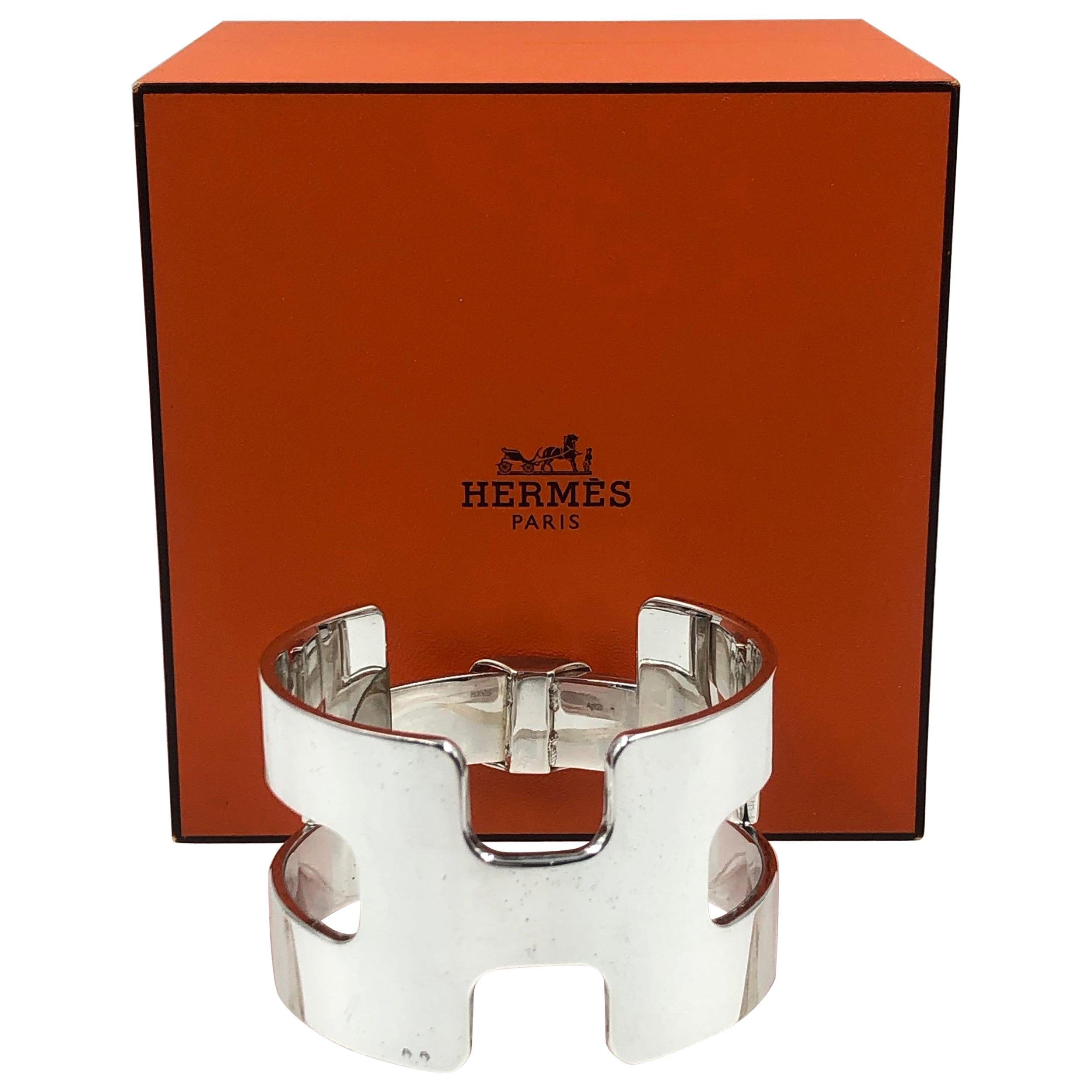 Hermés Classic H Sterling Silver Cuff Bracelet. 
Bracelet still has original plastic protection sticker on the clasp.
Bracelet was purchased at Hermés Beverly Hills.
Bracelet comes with original box and cover.
Bracelet was worn once and stored it's