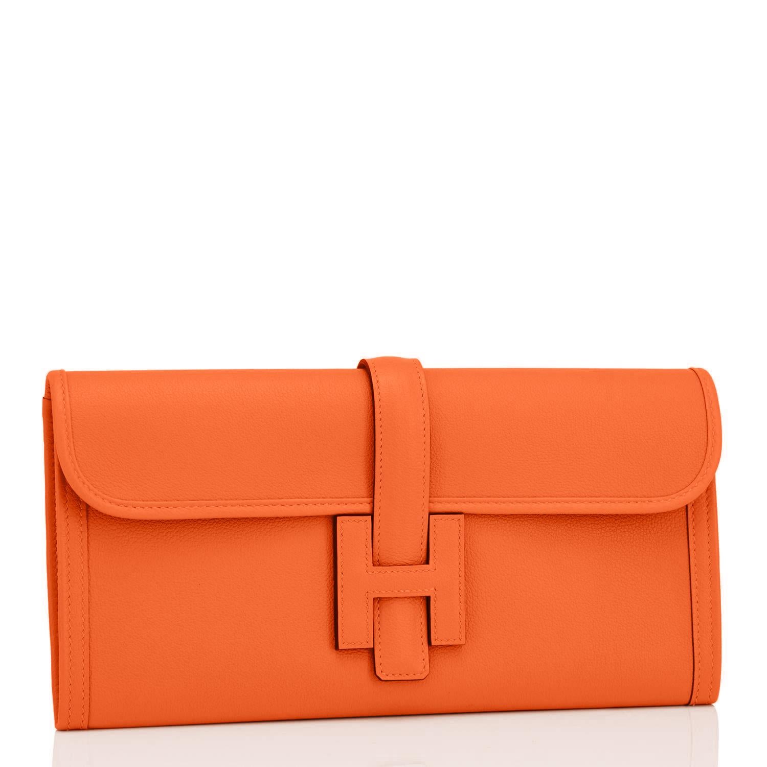 Hermes Classic Orange Jige Elan Clutch Bag 29cm NEW RARE
Perfect Gift!  New or Never Worn. Pristine condition.  
Comes in full set with Hermes dust bag, Hermes ribbon, and Hermes box.
Classic Hermes Orange is perhaps the most loved color in Hermes