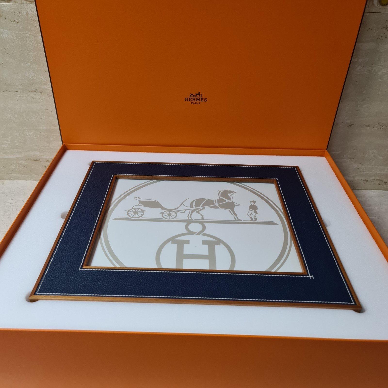 Hermes Classic Pleiade Blue Regate Leather Photo Frame
Color: Bleu Regate (Blue)
Size: Measures 33.5 cm x 28.5 cm, fits a 25 cm x 20 cm photo 
Material: Calfskin with solid natural mahogany
Country of Origin: France

Brand New in Box. Store Fresh.