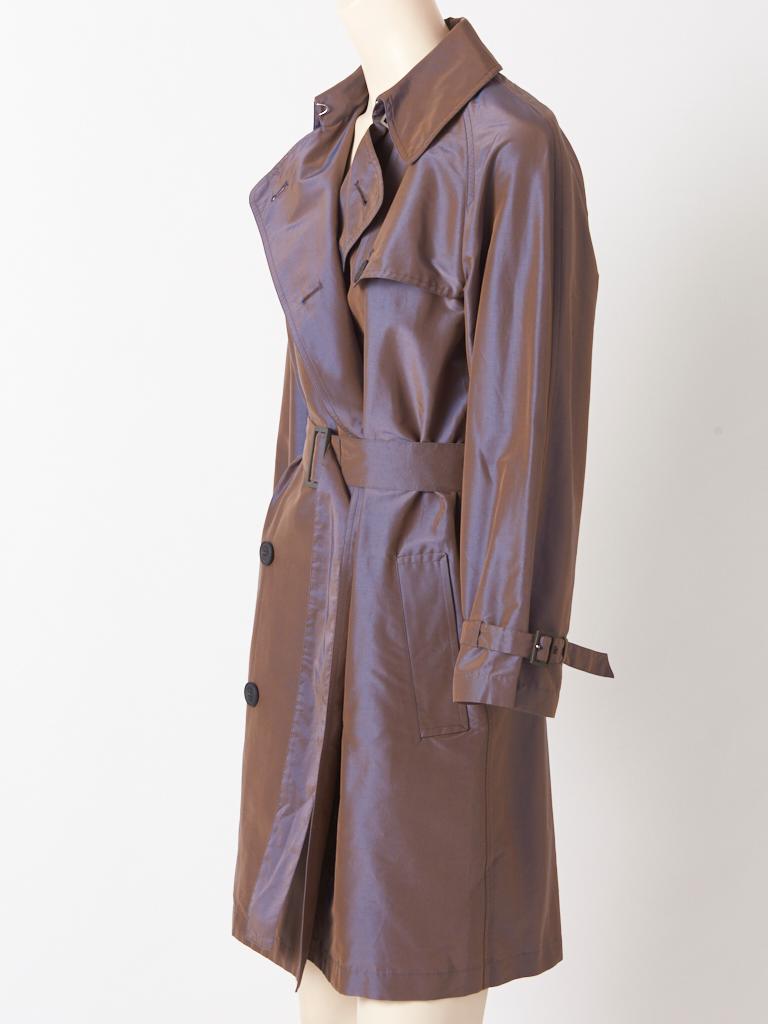 Hermès, blue tone, iridescent, cotton and silk, classic, double breasted, belted, short trench having generous, notched lapels, and slash pockets.
Fabric content: 29% silk and 71% cotton. 