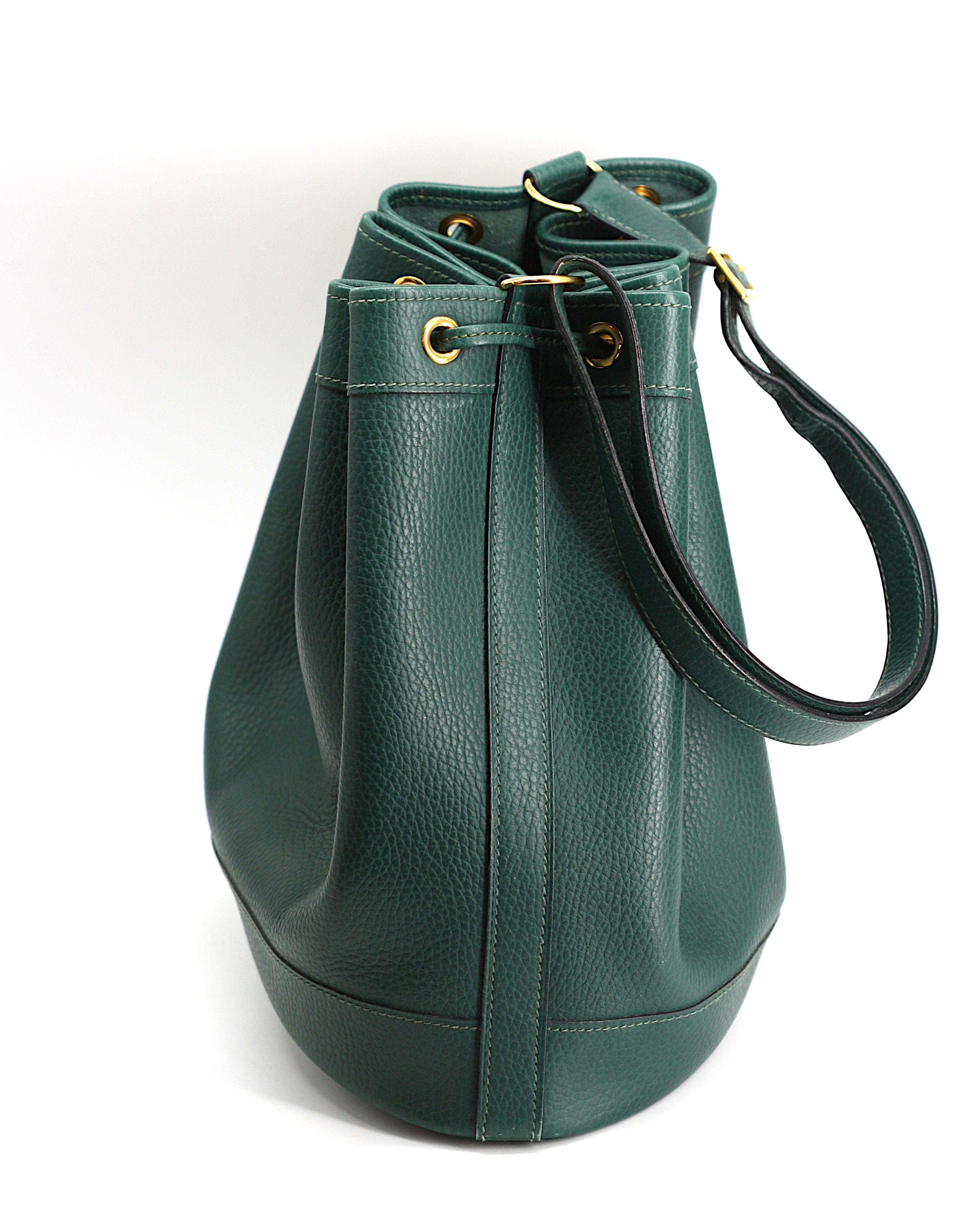 
Hermes Clemence Leather Market Shoulder Bag
Marked on the underside. Forest green Taurillon Clemence leather, gold-toned hardware, double pull strap closure, with adjustable shoulder strap.
Height of bag approx. 10 in., Width at oval bottom 10.75