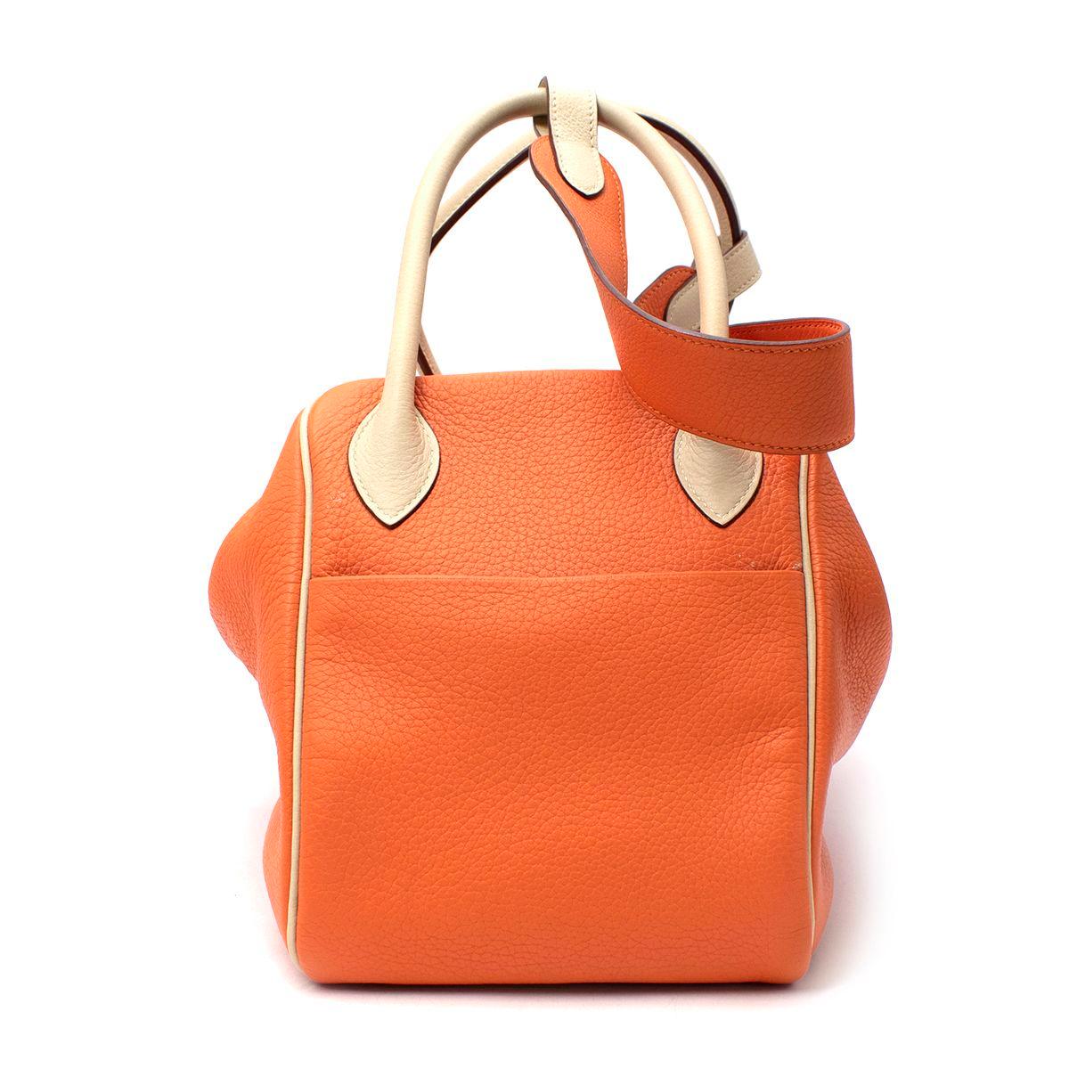  Hermes Clemence Leather Orange & Parchemin Lindy 34 PHW
 

 - Age [M] 2009
 - This Hermes Lindy bag comes in soft orange Clemence leather with contrasting parchemin hued handles, belt & piping
 -A large interior compartment with two side interior