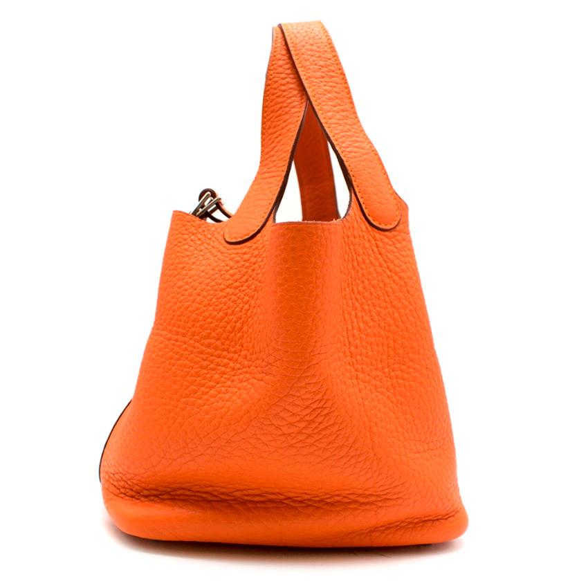 Hermes Clemence Leather Orange Poppy Picotin Lock 18

- Age [M] 2009
- Design is inspired by a equestrian feed bag
- Orange clemence leather
- Silver-tone hardware with metal padlock and key fastening
- Metal feet
- Flat top handles
- Unlined

Made