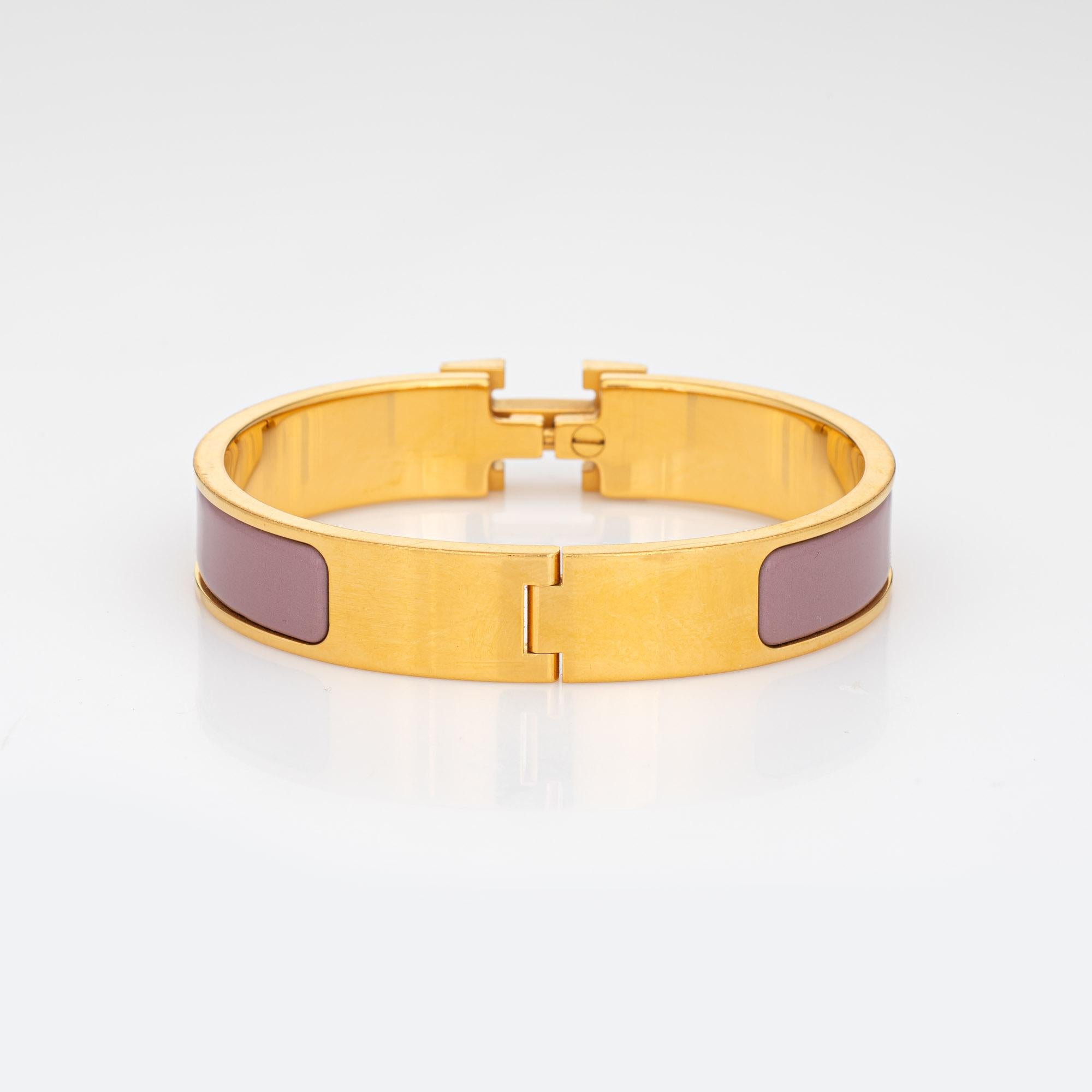 Pre-owned Hermes clic clac bracelet (circa 2013). 

The narrow Hermes bracelet features purple mauve enamel detail and yellow gold plate. The H turnlock secures the bracelet onto the wrist. Dating to 2013, the bracelet is in very good condition