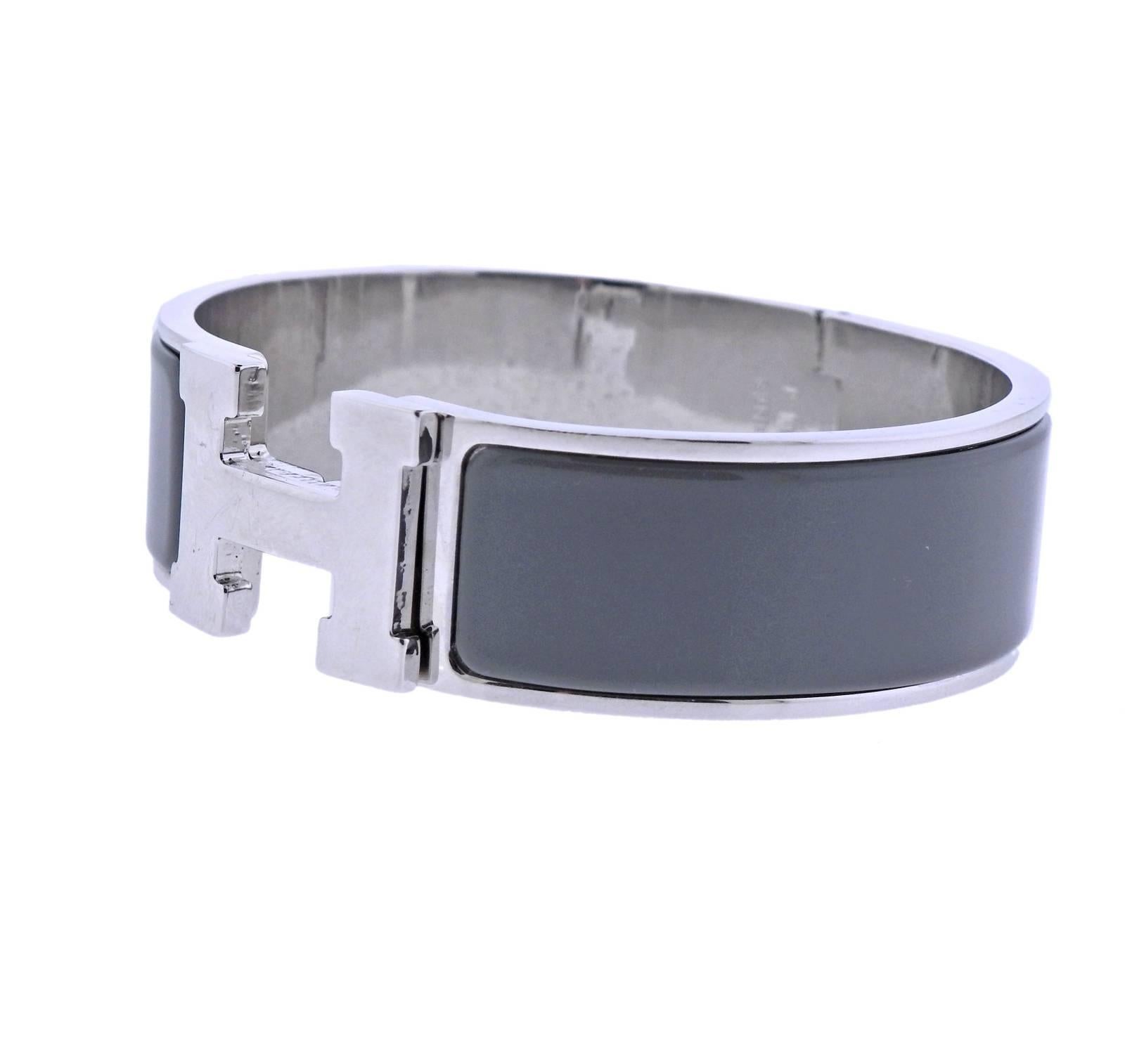 Iconic Clic Clac H bracelet, crafted by Hermes, decorated with grey enamel. Retail $660. Bracelet will fit approx. 7.25