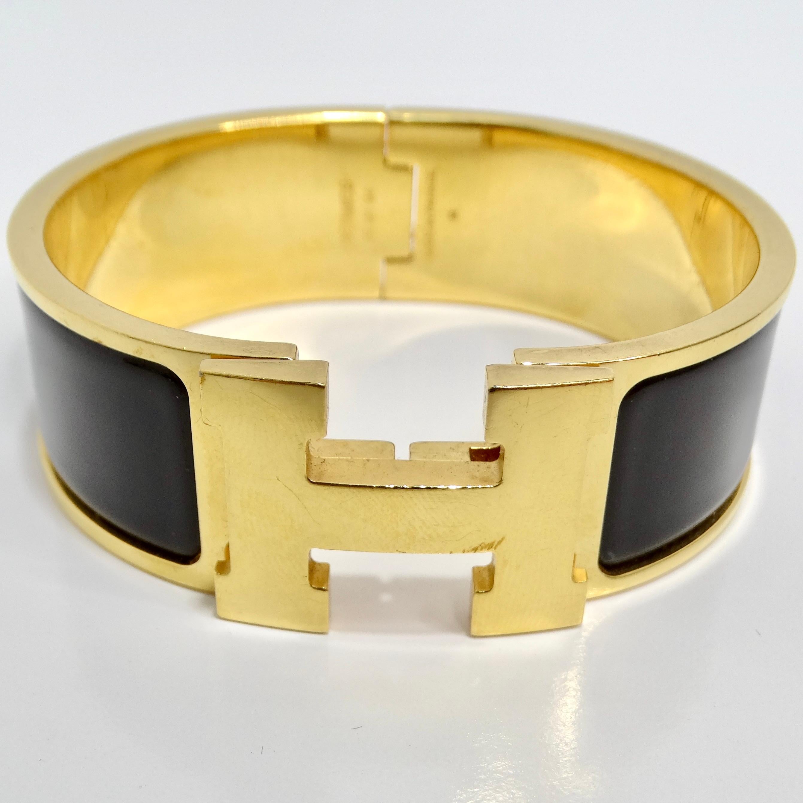 Indulge in iconic style with the Hermes Clic Clac H Black Enamel Gold Plated Bracelet – a versatile and timeless accessory that adds a touch of luxury to your ensemble. This bracelet features a gold tone with a hinge on one side, ensuring easy wear,