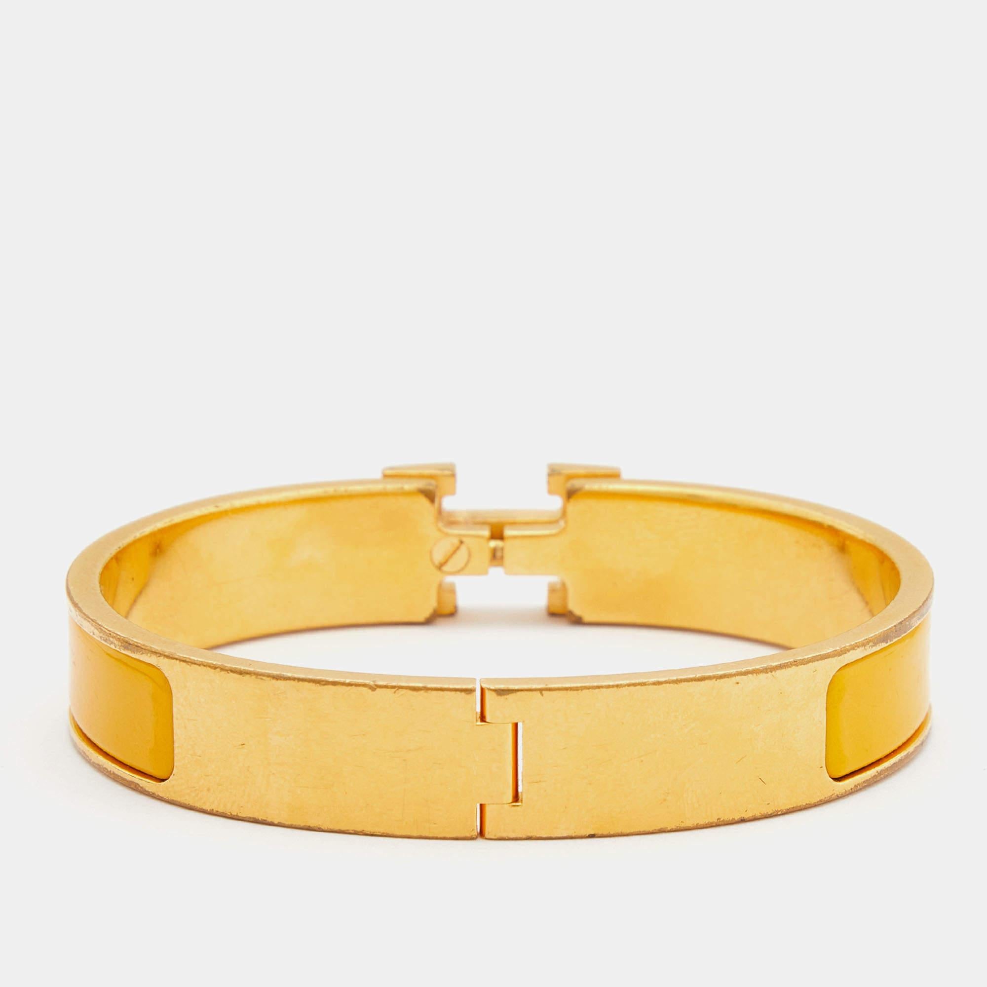 This bracelet embodies Hermès’ elegant craftsmanship with its gold-plated metal body and enamel inlay. Featuring the iconic H logo of the fashion house at the front, this bracelet is the accessory to buy today!

