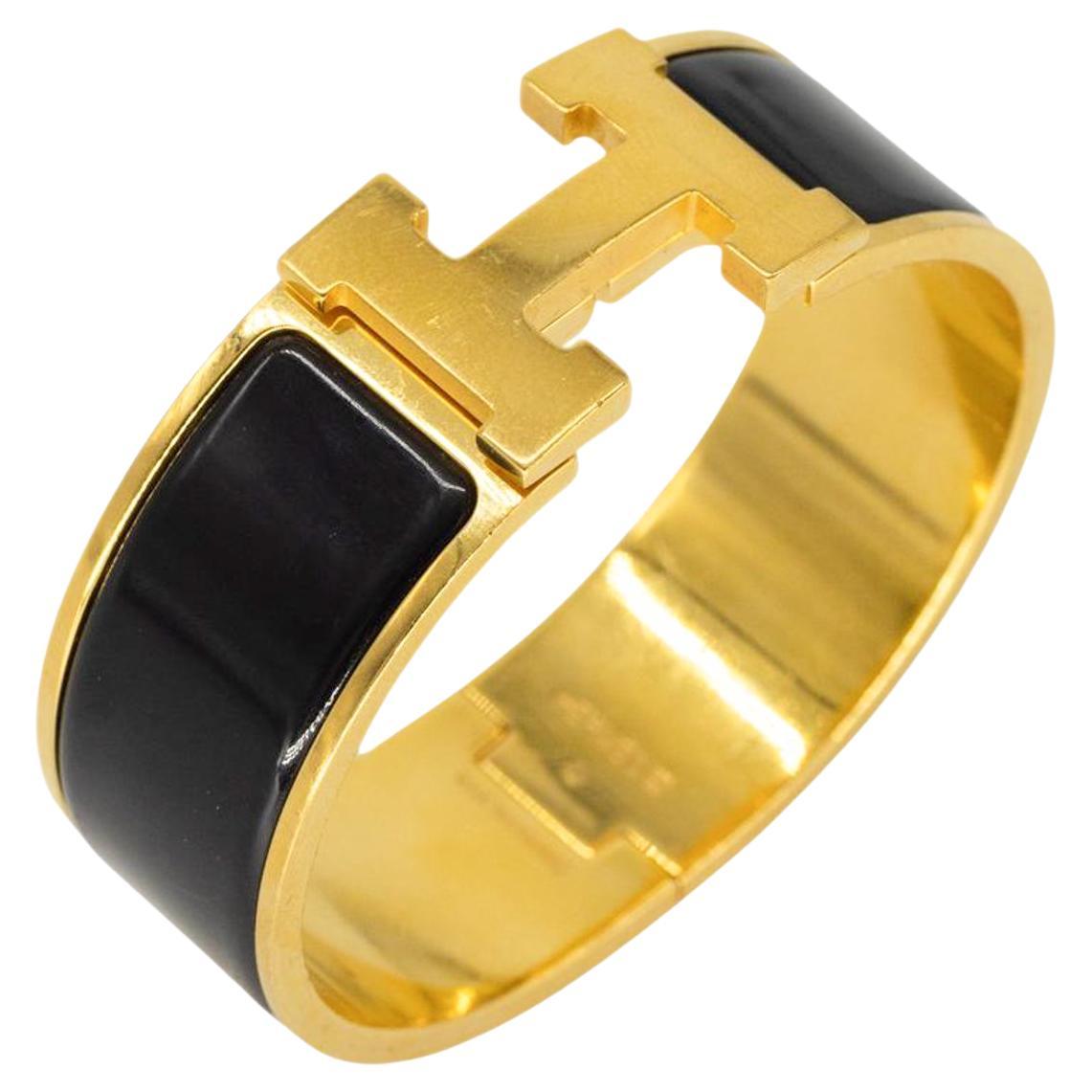 Hermès "Clic Clac" H Gold Plated Metal and Black Enamel Bracelet, 2011.