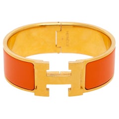 Hermès Clic Clac H - Bracelet large en plaqué or et émail orange
